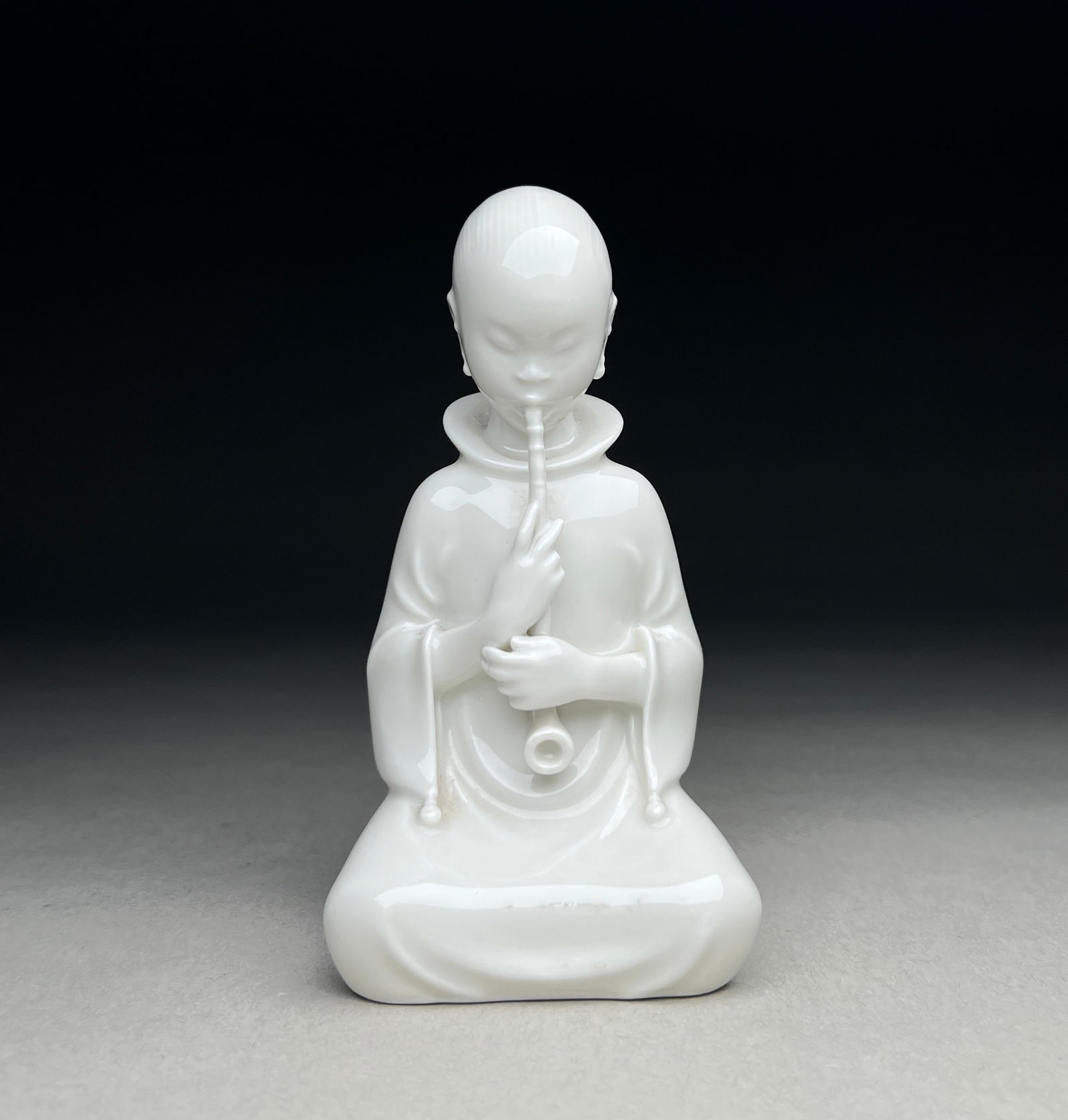 Royal Copenhagen Porcelain Figurine "The Opium Smoker" by Arno Malinowski - 1930s: Royal Copenhagen Porcelain Figurine "The Opium Smoker" - Designed by Arno Malinowski, 1930s This porcelain figurine by Arno Malinowski reflects the early 20th-century fascination with oriental themes,