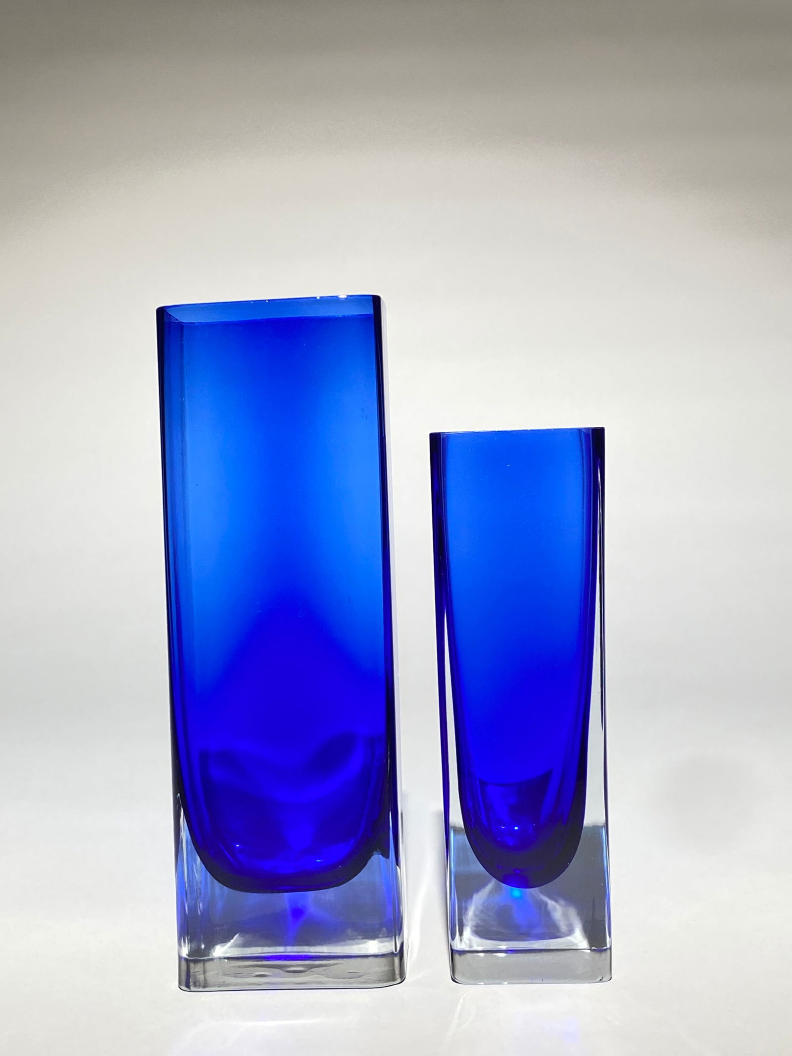 Pair of Aseda Mid Century Modern Cobalt Blue Glass Sommerso Vases attributed, Mid - 20th century: Pair of Aseda Mid Century Modern Cobalt Blue Glass Sommerso Vases attributed, Mid - 20th century A pair of Scandinavian art glass vases features vibrant cobalt blue glass encased in clear glass using