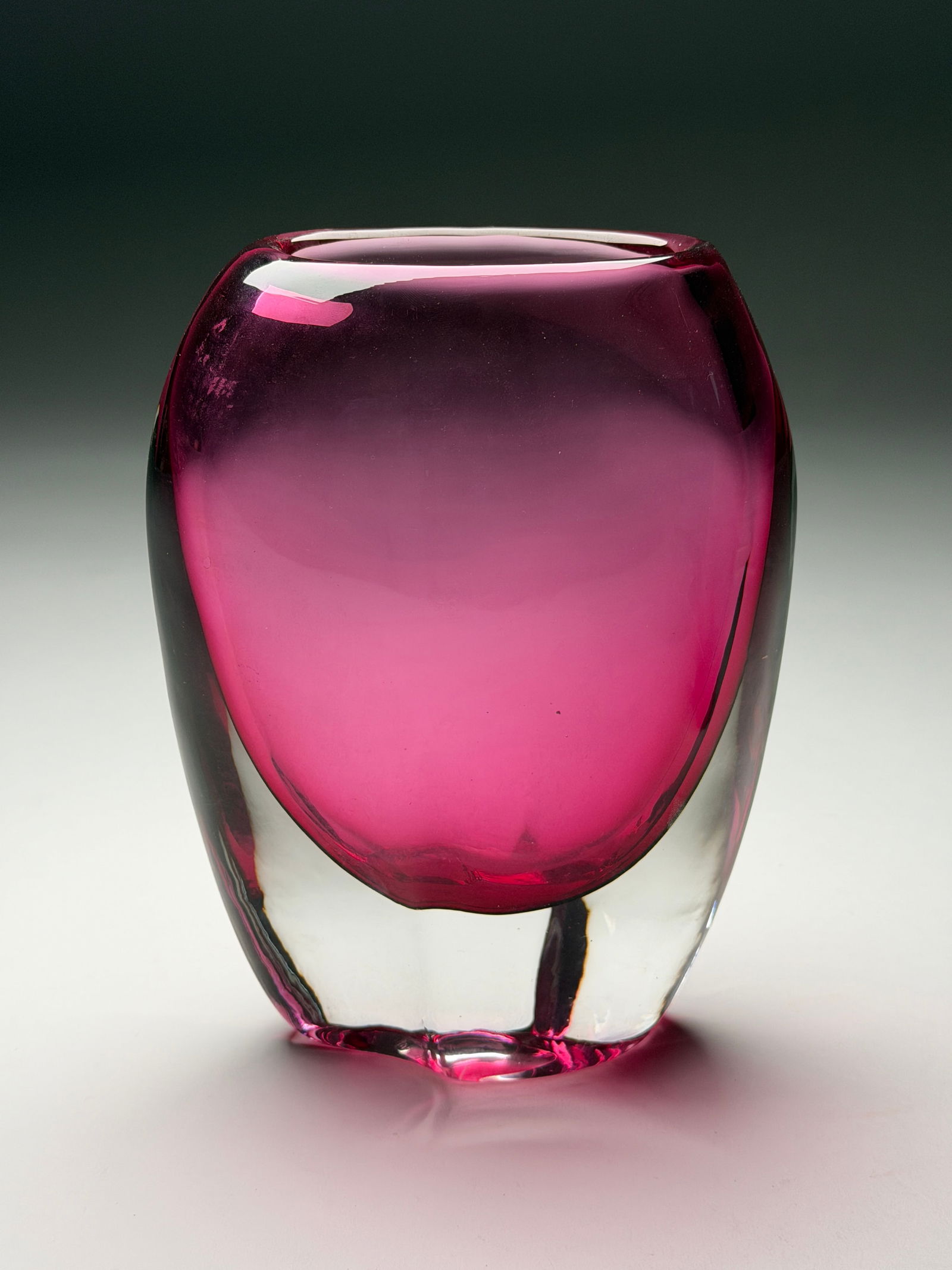 Josef Schott Hot Pink Glass Vase for Smalandshyttan - Mid 20th Century: Josef Schott Hot Pink Glass Vase for Smalandshyttan - Mid 20th Century This striking vase features a rounded form with gently tapering sides and a softly flared rim, resting on a subtly irregular base