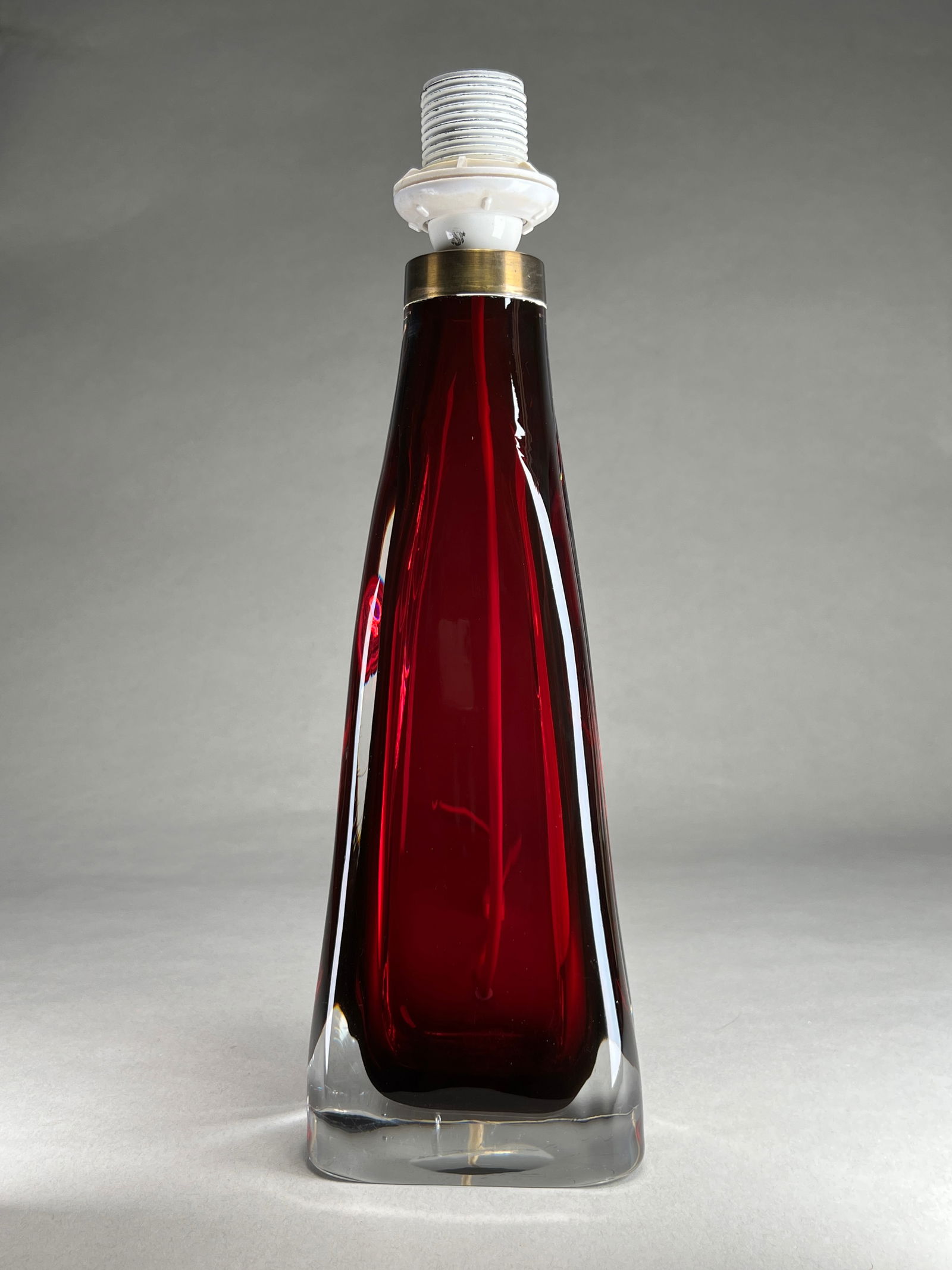 Carl Fagerlund Ruby Glass Table Lamp for Orrefors - c.1960s: Carl Fagerlund Ruby Glass Table Lamp for Orrefors - c.1960s Table lamp featuring a conical ruby red glass body rising from a substantial clear crystal base with faceted corners. The deep crimson glass