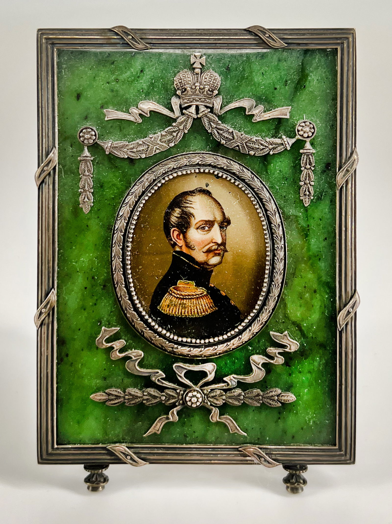 Russian silver mounted jade (nephrite) portrait frame depicting Emperor of Russia Nicholas I.: The backside of the frame was not opened for inspection. Rectangular shape on toupie feet, centering an oval aperture within a silver beaded and laurel leaf border. A silver laurel garland is suspende