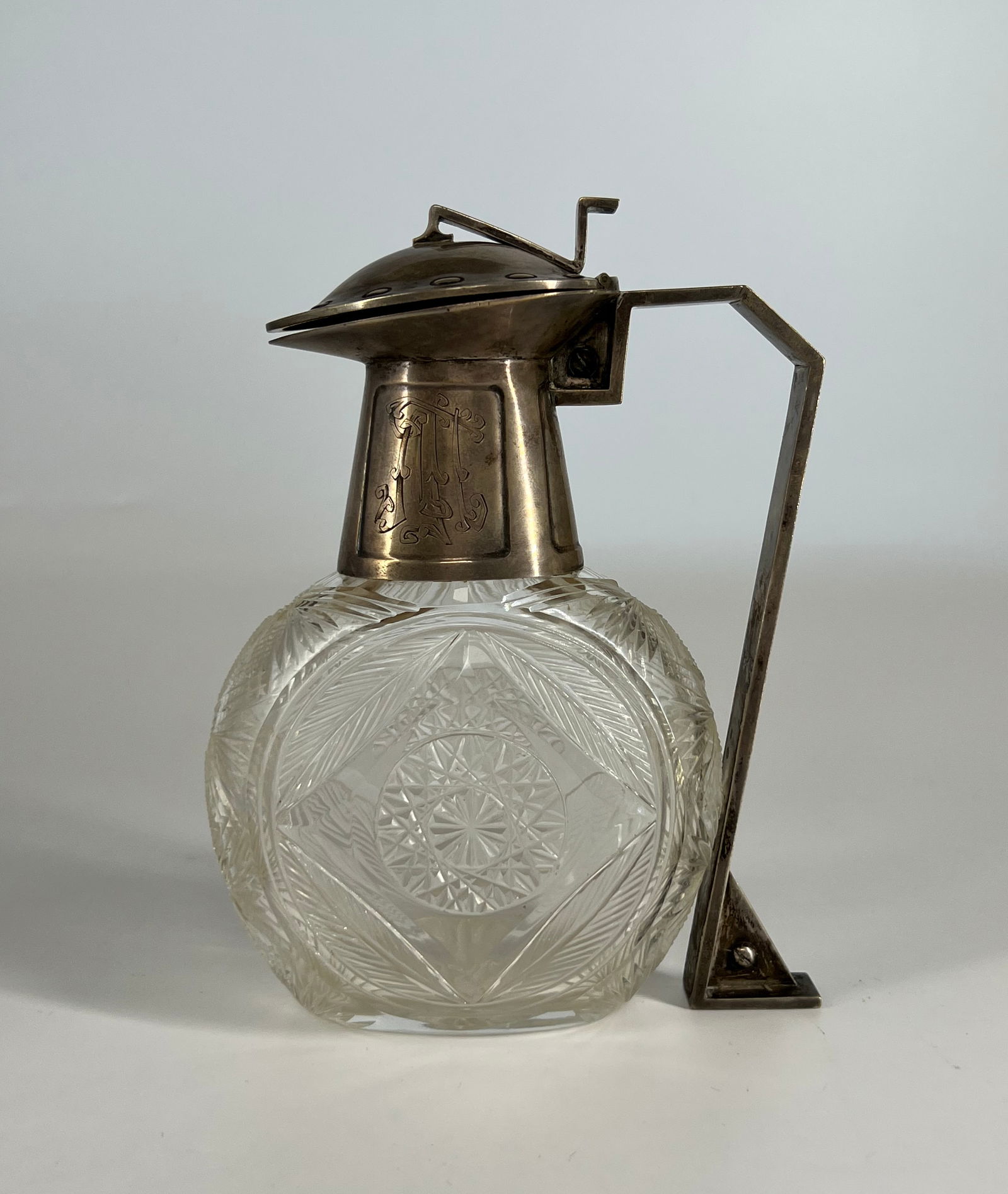 A Very Fine Imperial Russian Silver Mounted Carved Crystal Decanter - Circa 1910: Russian Empire, Moscow 1908-1916. Marked: "Lorie", Fyodor firm Silver, translucent colorless crystal; faceting, casting, presswork, carving. Marks: "Lorie" alloy number "84". Colorless transparent cry