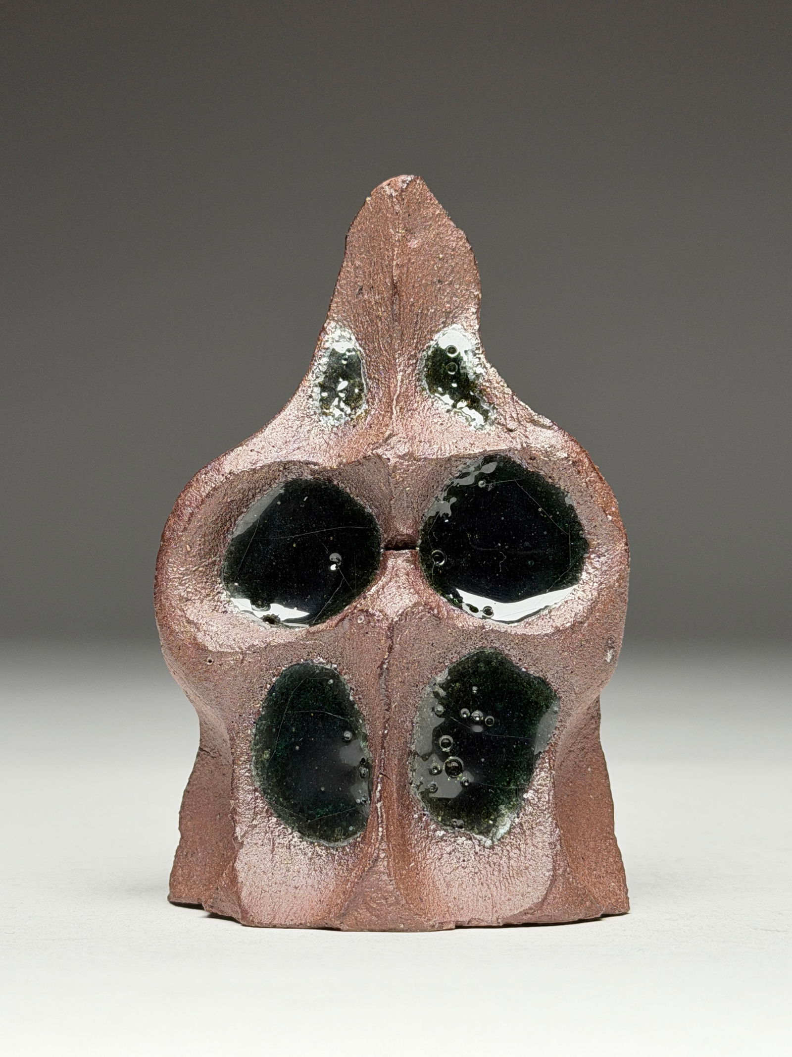 Yve Mas (1997-) Ceramic Decorative Tribal Mask - 2020: Yve Mas Ceramic Decorative Tribal Mask - 2020 This vertically oriented ceramic mask rises in a tapered, totemic form, its silhouette narrowing toward a pointed crest that suggests both ritual object a