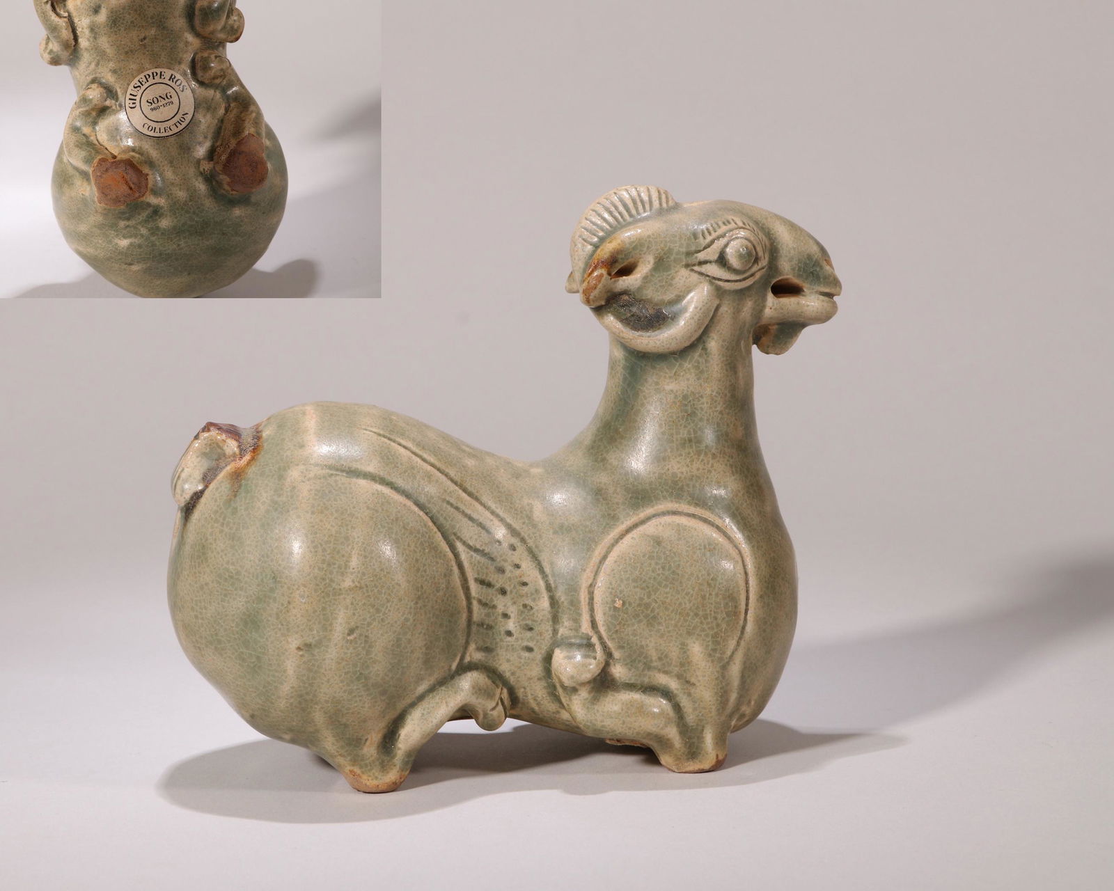 CHINESE PORCELAIN CELADON GLAZE COUCHING GOAT: CHINESE PORCELAIN CELADON GLAZE COUCHING GOAT. L.13cm. H. 12cm. LOT252 TO LOT344 FROM COLLECTION OF ITALIAN DIPLOMAT GIUSEPPE ROS 1883-1948. Giuseppe Ros (1883-1948) was born in Naples, Italy on Augus