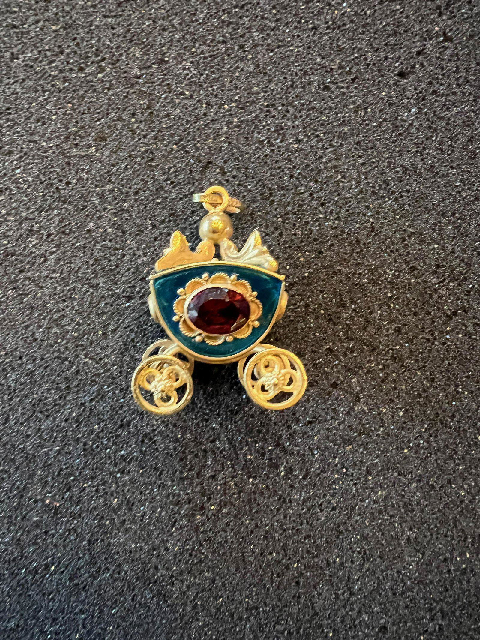 18K Garnet and Guilloche Coach Pendant: Finely cast Italian 18K coach pendant with blue guiloche sides. Total weight 15.5 grams.