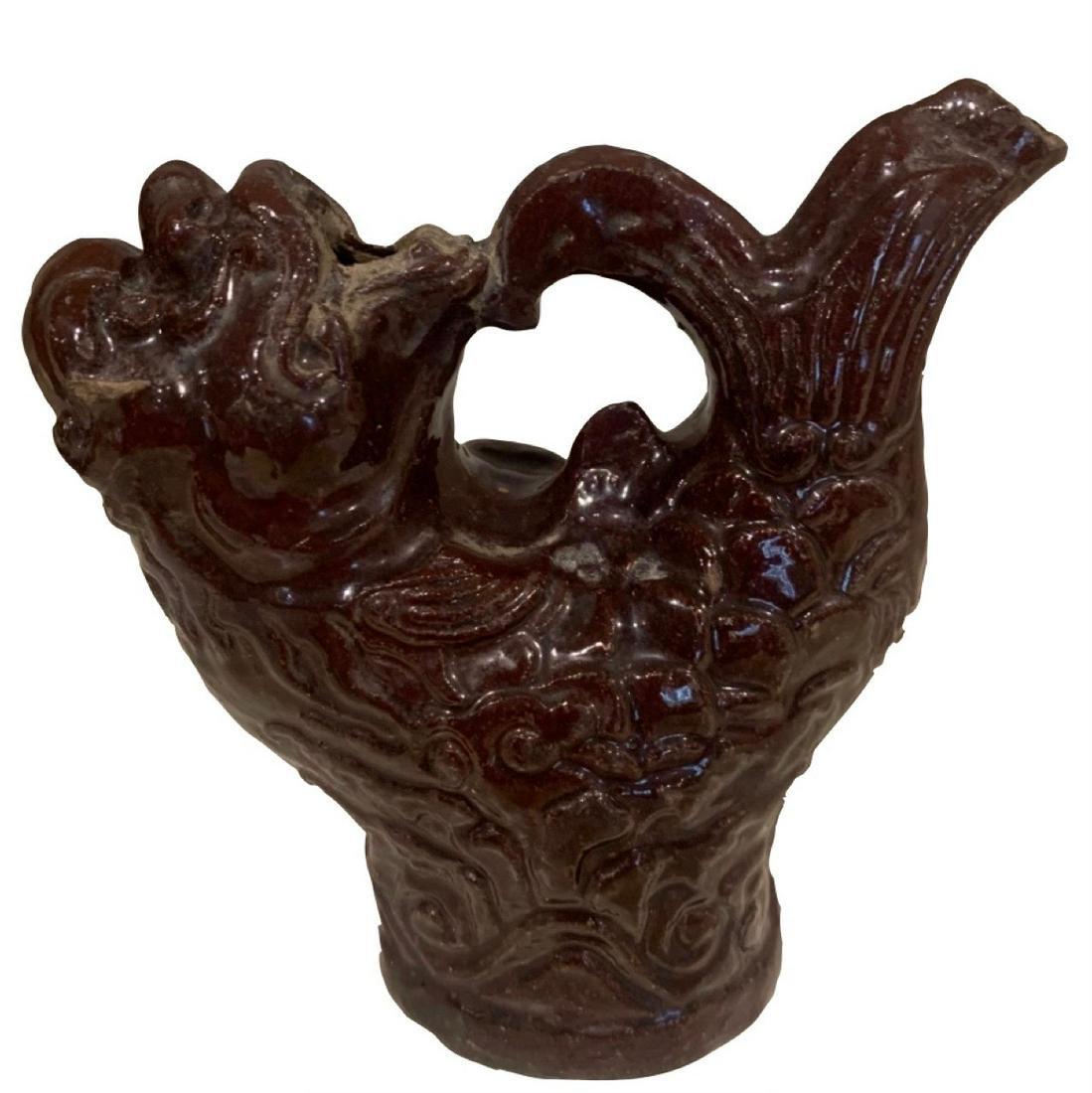 Tang Animalistic Wine Vessel, 7th/10th Century, China: Very unusual dark brown glazed pouring vessel in the form of a fish with a human face dates to the Tang Dynasty (618-907), 5.5 inches.