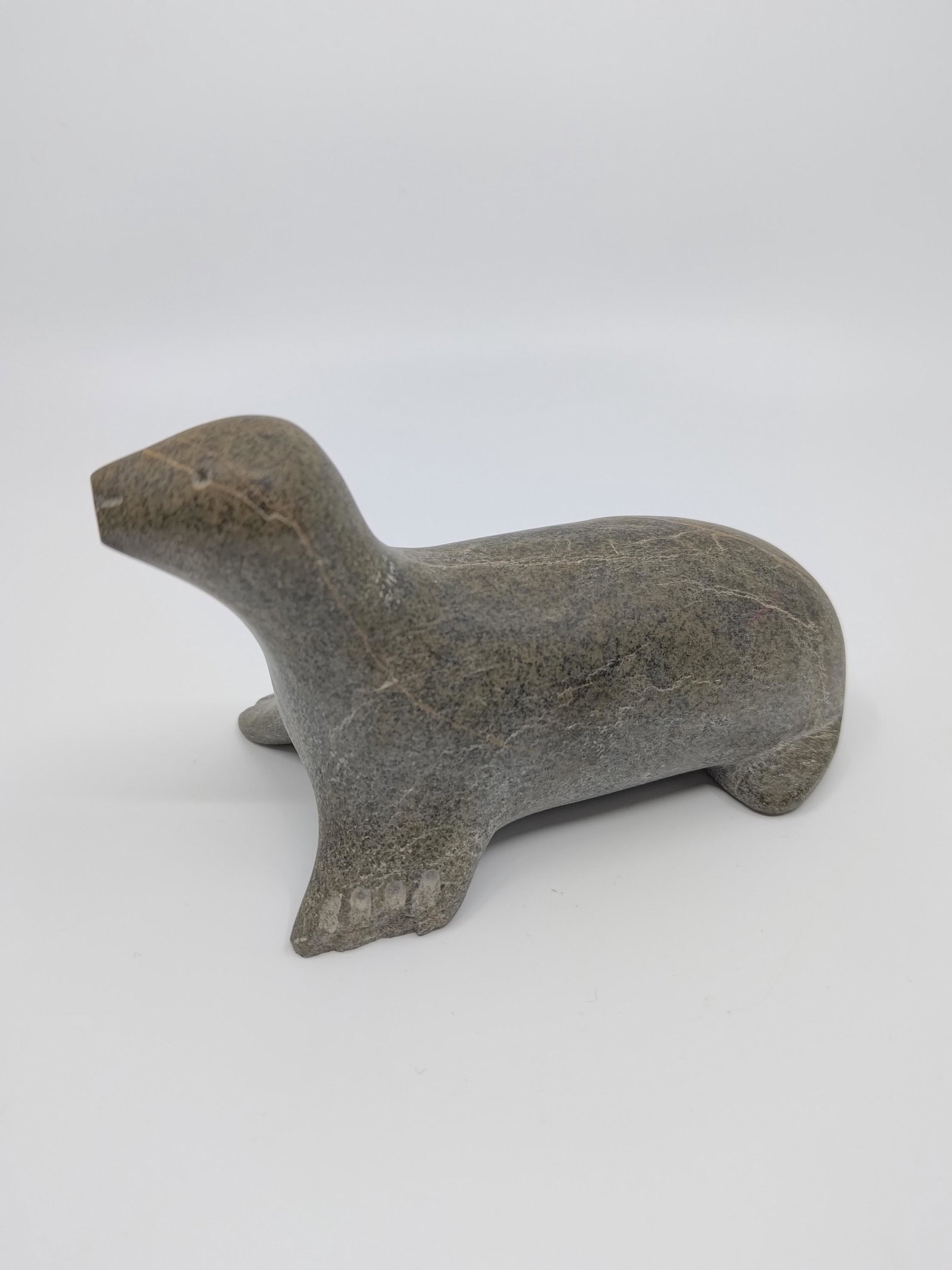 Uppik, David (1951- ) Belcher Islands / Sanikiluaq, Seal: Artist : Uppik, David (1951- ) Belcher Islands / Sanikiluaq Title : Seal Description (FR) : Sculpture en pierre a savon, avec papiers Description (ENG) : Soapstone sculpture, with papers Dimention (PO