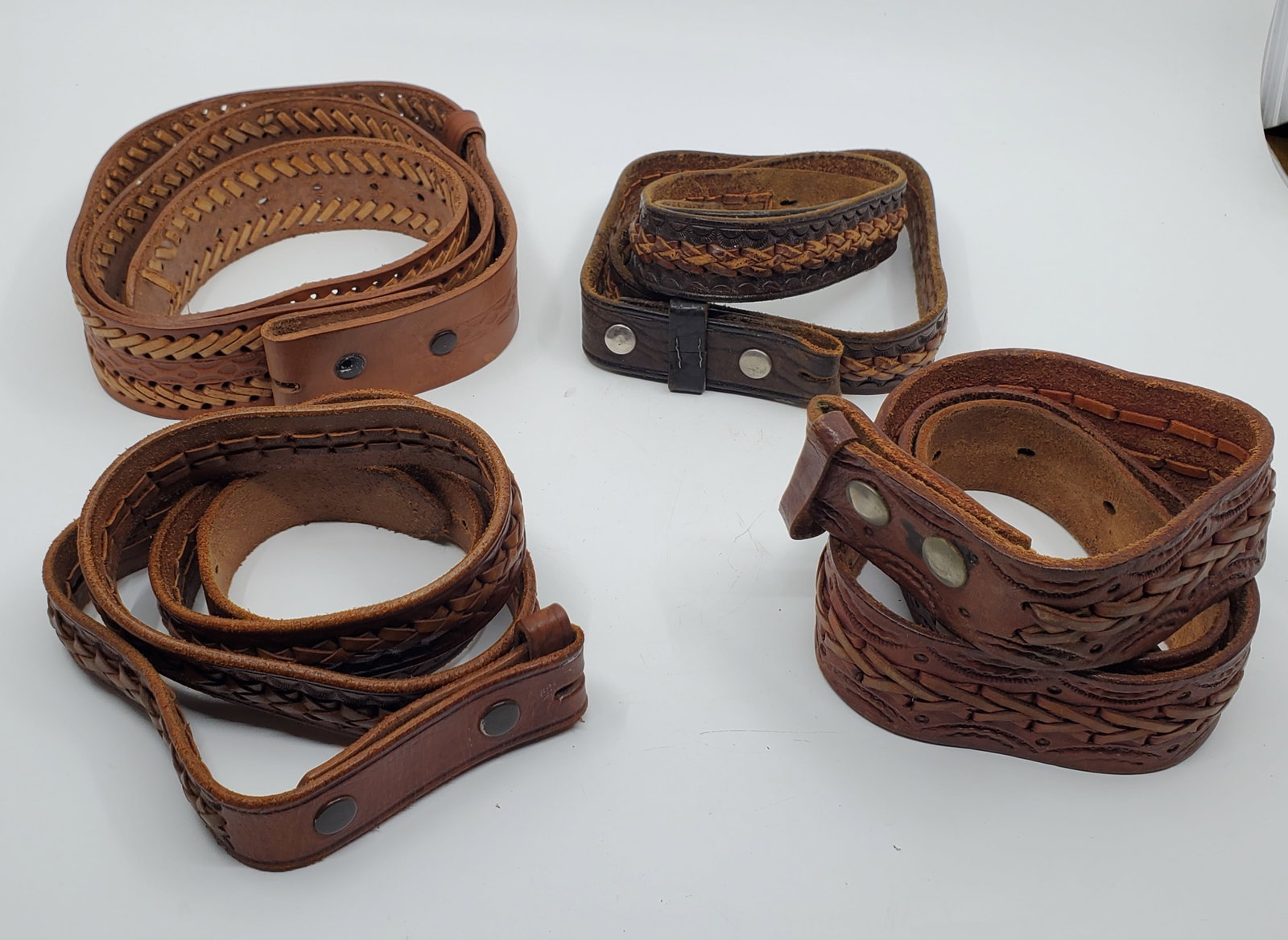 Lot of 4 Hand Made Leather Belts For Belts Buckle: Possibly of Mexican origin. 1) 4 x 110 cm 2). 4 x 123 cm 3). 3 x 122 cm 4). 3 x 125 cm.