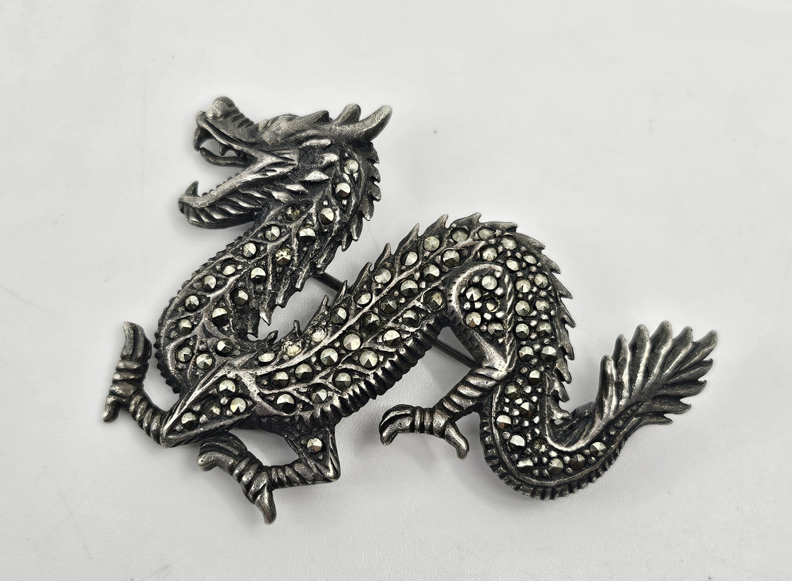 Vintage Sterling Silver Dragon Brooch set with Marcasites: Sterling Silver Brooch Set with Marcasites, signed on the back 925 1 1/2" x 2" Weight: 13,2 g