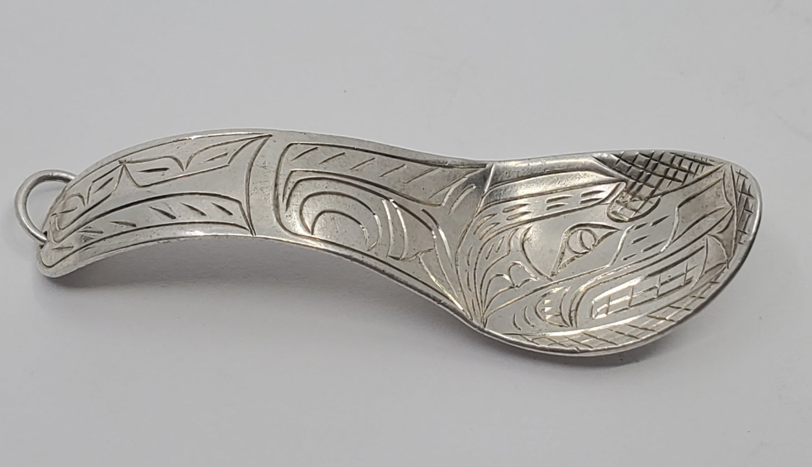 Haida North West Coast Sterling Silver Killer Whale Pendant: Sterling Silver Pendant, representing the Killer Whale, pendant in a Spoon shaped, unmarked 2" x 3/4" Weight: 4,5 g