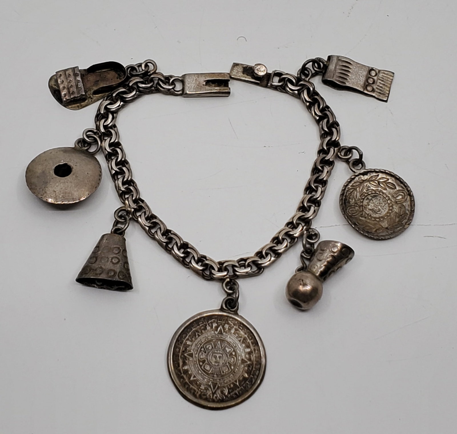 E.V.B, MEXICO Sterling Silver Charm Bracelet: 14,92 grams. Stamped : E.V.B. 925 STERLING Hecho en Mexico With 8 charms., 6 1/2" long