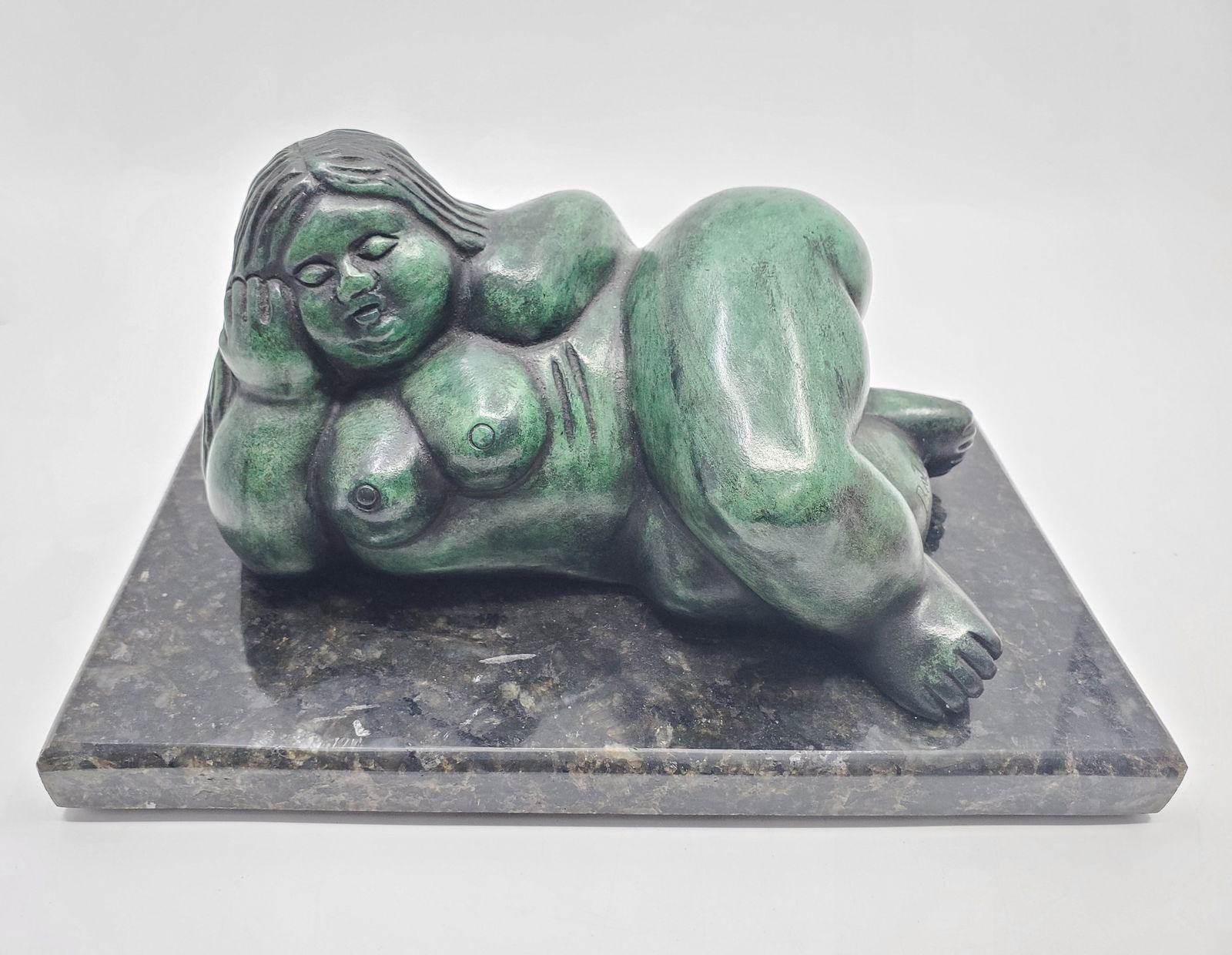Botero, Fernando (1932-2023) Colombian, woman lying down: Bronze Sculpture with green patina, signed on the side Botero, on granite base, No certificate 4 1/2" x 8" x 5"