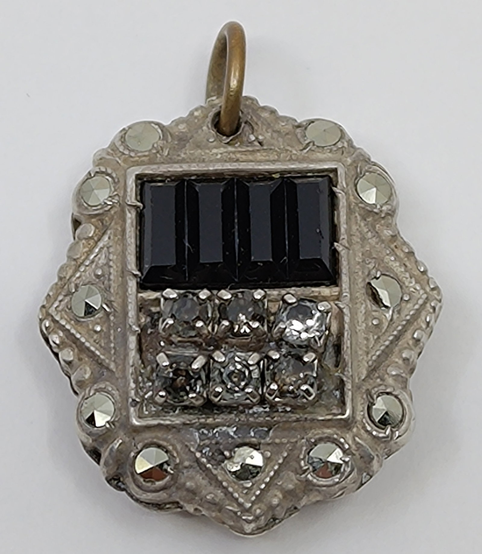 Antique Sterling Silver Pendant set with Marcasites and Onyx: Antique Sterling Silver Pendant, set with Marcasites, Onyx and stones, signed on the back Sterling 1" x 3/4" Weight: 5,6 g
