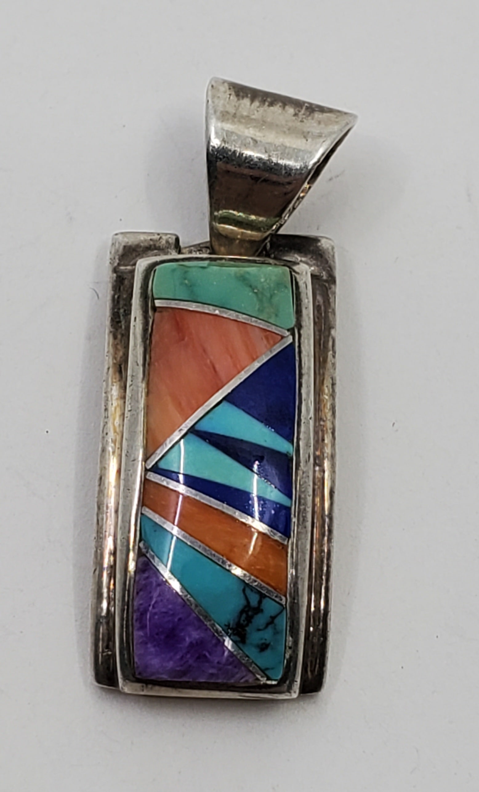 Vintage Zuni Sterling Silver Pendant: Sterling Silver Pendant, set with Malachite, Spinel Oyster, Lapis Lazuli and turquoise, marked on the back 1 1/4" x 1/2" Weight: 7 g