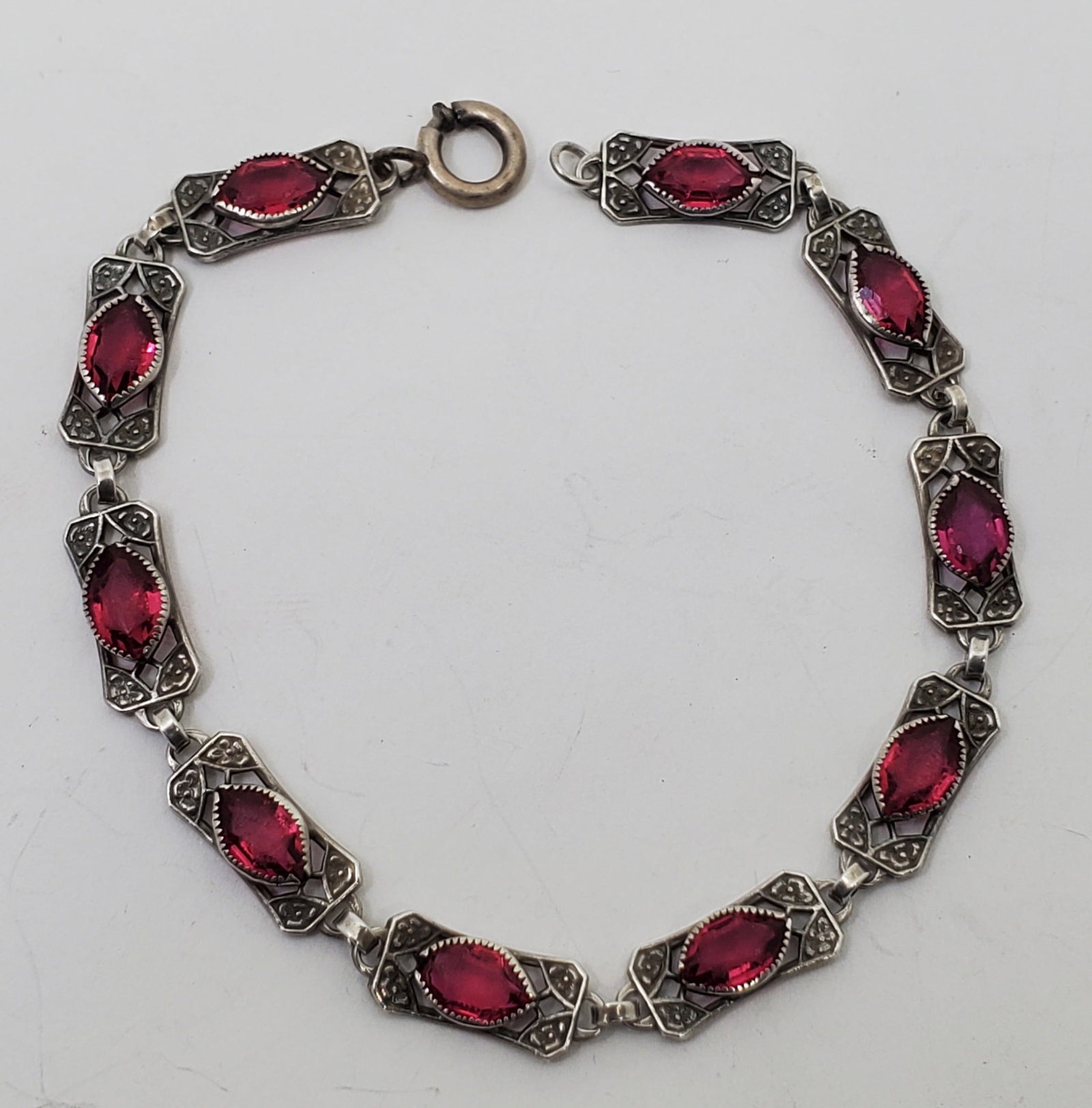 Antique Sterling Silver Pink Stones Bracelet: Sterling Silver Bracelet, set with Pink Stones, signed Sterling 7" x 1/4" Weight: 7,7 g