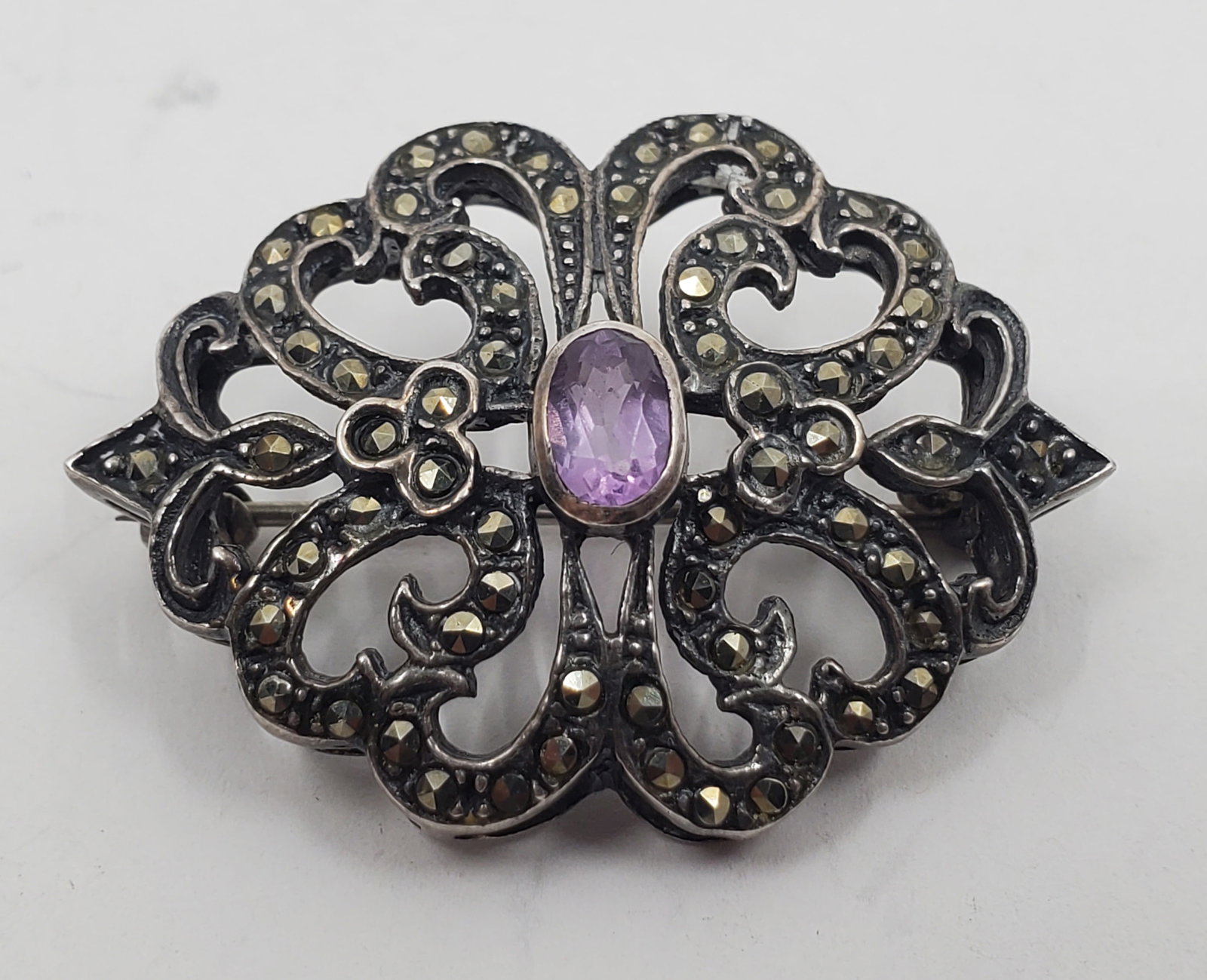 Antique Sterling Silver Marcasites and Aquamarine Brooch: Sterling Silver Brooch set with a central Aquamarine and marcasites, unmarked 1 1/2" x 1" Weight: 7,3 g