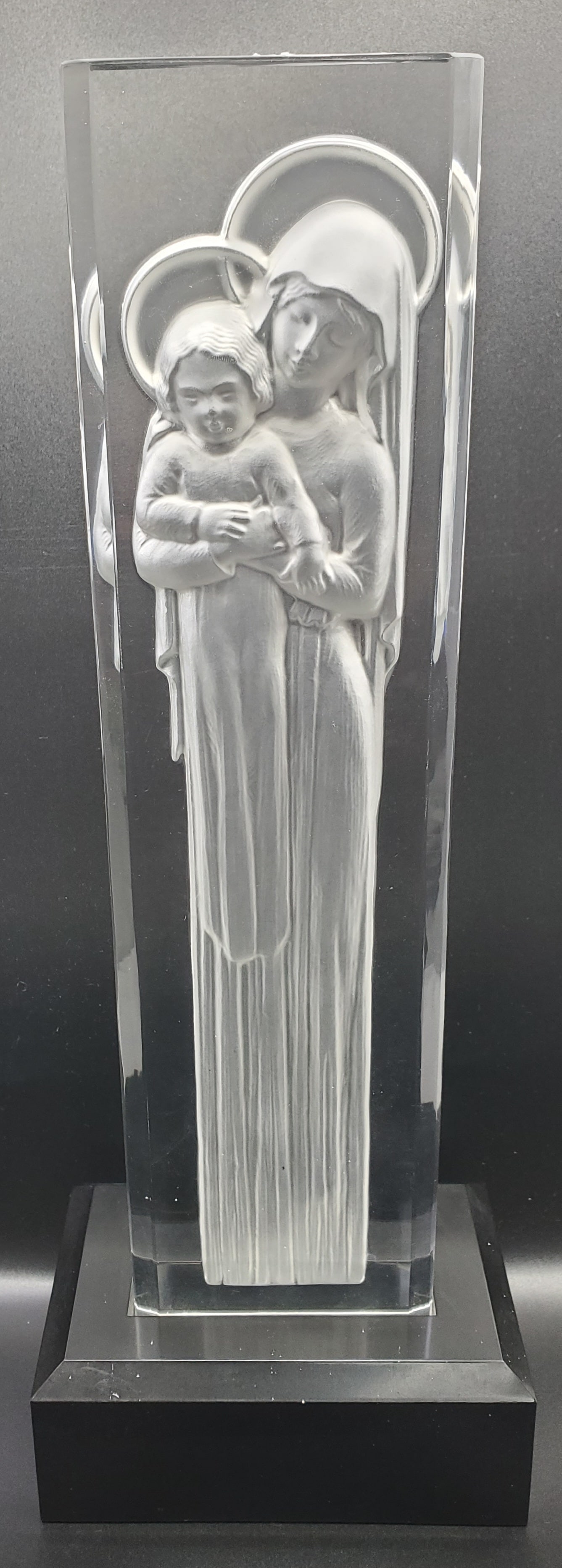 Lalique France, Madonna and Child Sculpture: Crystal sculpture on wooded base, representing the Madonna and Child, signed on the side Lalique France 13" x 3 1/2" x 1 1/2"
