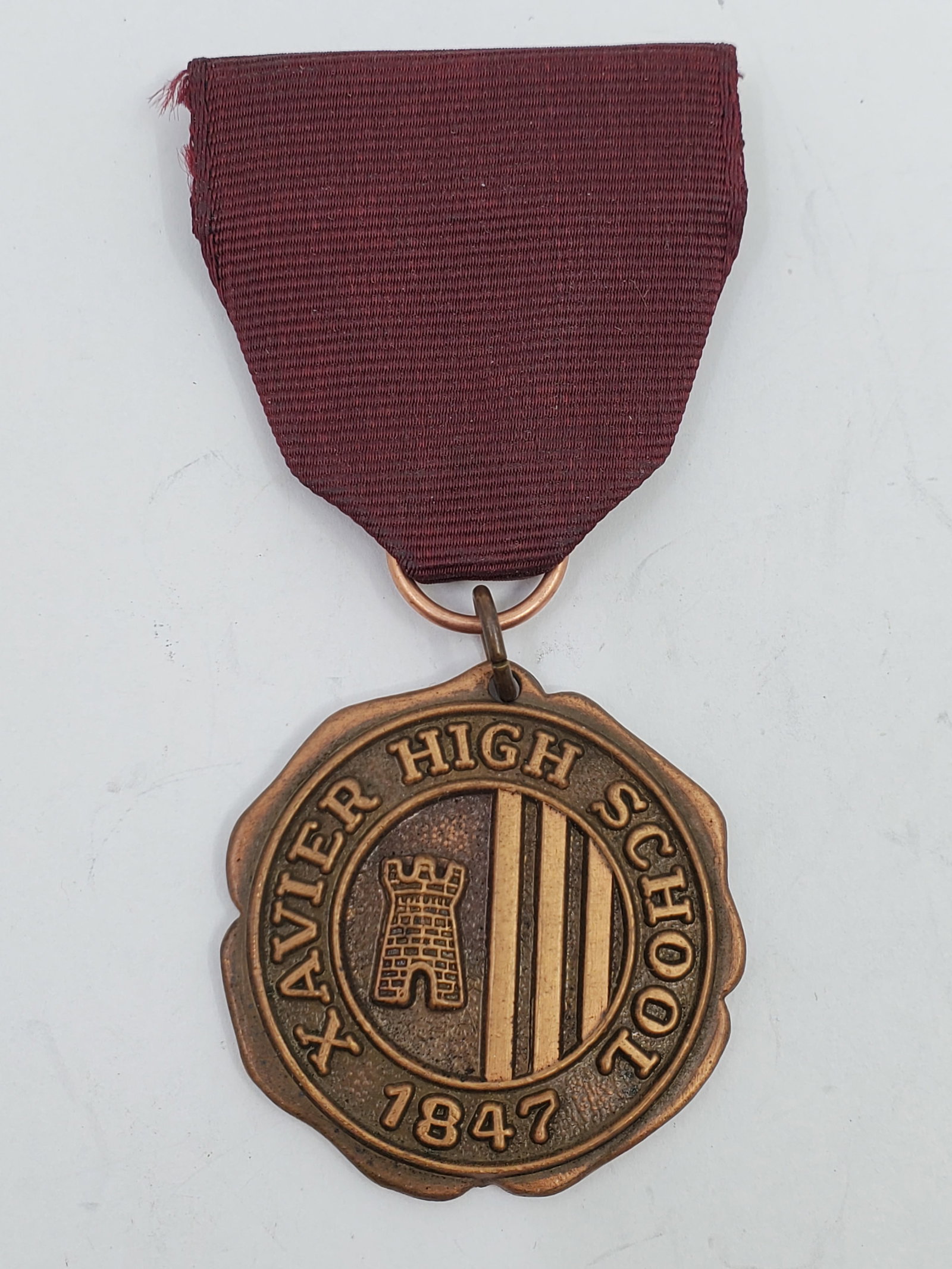 Vintage Bronze Medal XAVIER HIGH SCHOOL: Most probably an athletic award. 18.21 gr total weight. 32 mm. With ribbon and bar for suspension.