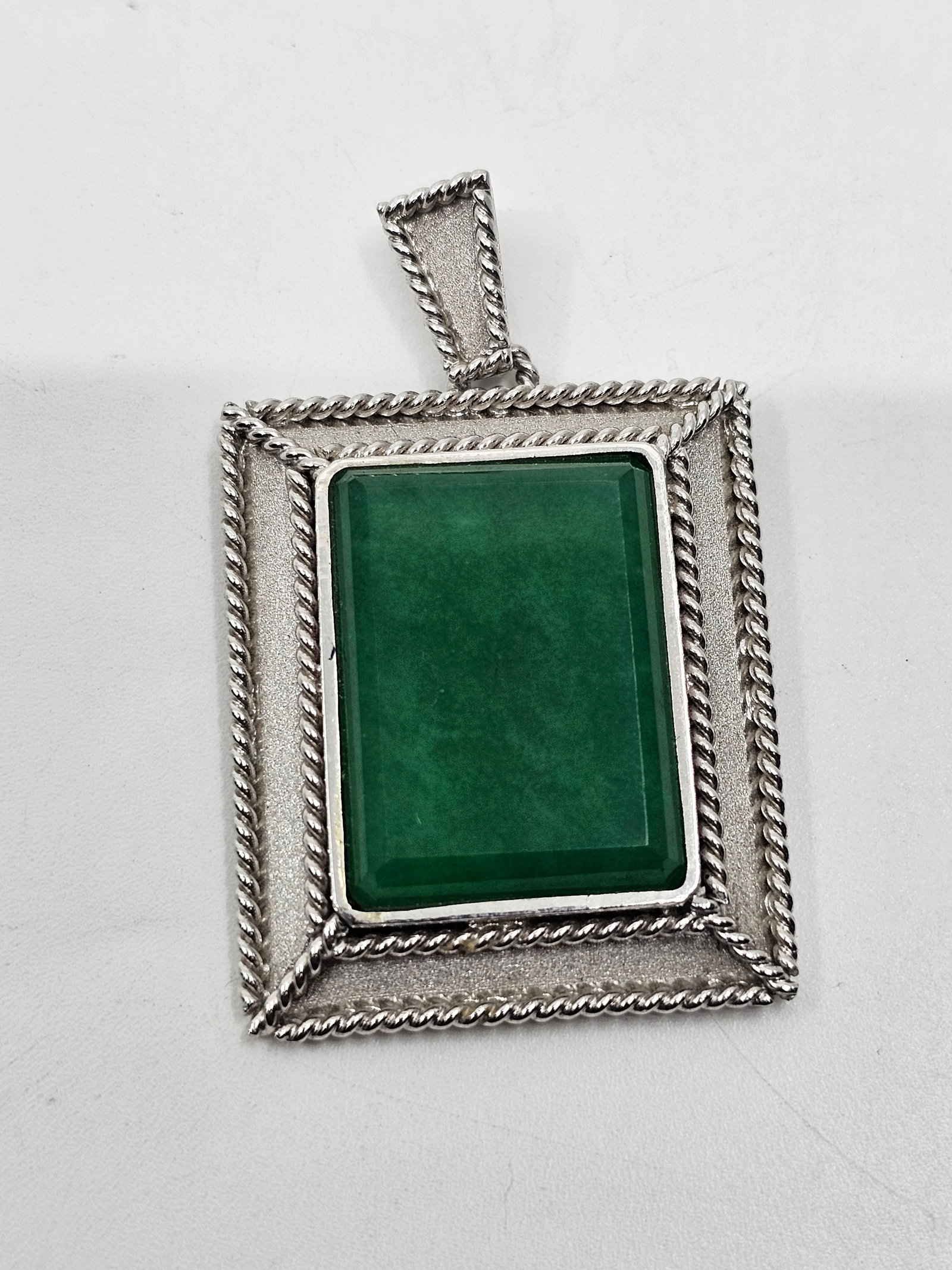 Vintage Sterling Silver Emerald Pendant: Sterling Silver Pendant, set with an Emerald, marked near the loop Silver 2" x 1 1/4" Weight: 15,5 g