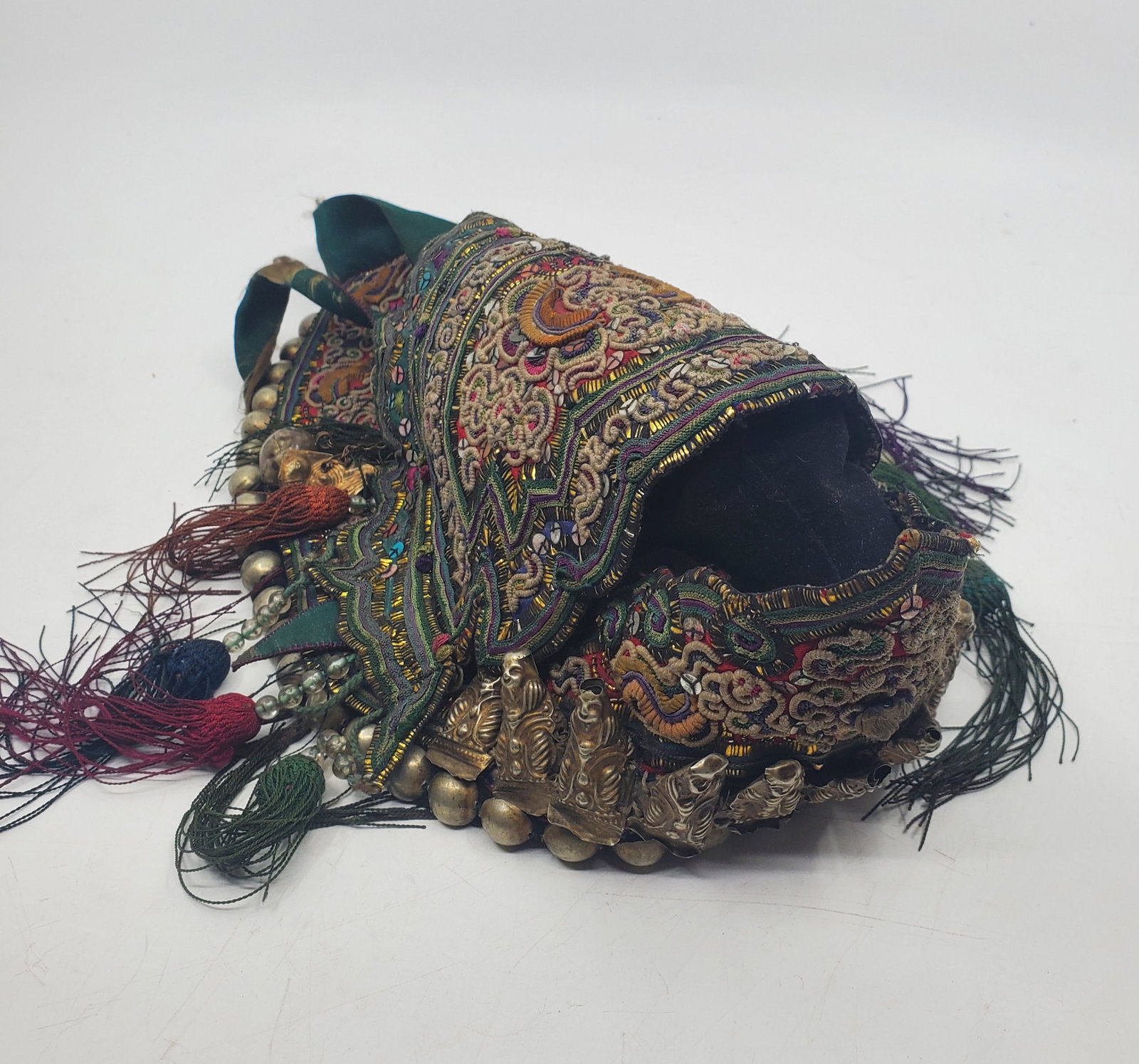 TIBET Antique Ceremonial Intricately Decorated Hat: Early 20th century/ c. 10 x 11" as measures across the bottom. 11 Silver Buddha figures along the lower fron. Very complex silver, silk and multi ornamented embroidery. Clearly was a very precious pos