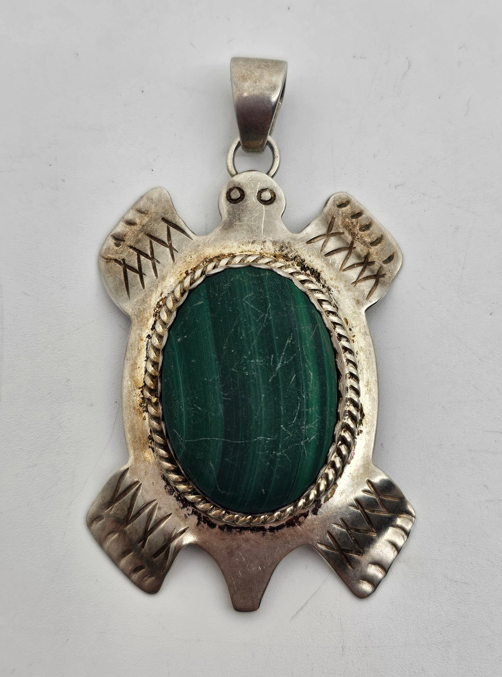 Gertie Ganadonegro, Navajo Sterling Silver Malachite Turtle Pendant: Sterling Silver Pendant, set with a malachite, marked on the back GG 925 2" x 1 1/2" Weight: 16,4 g