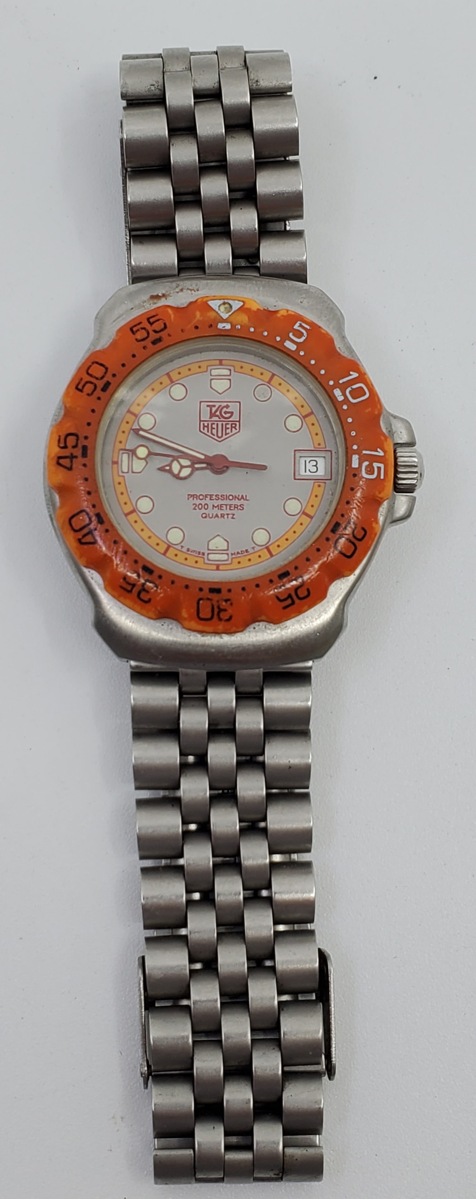 Tag Heuer Formula 1 Professional 200m Quartz mid-size, Orange Bezel Watch: Tag Heuer, Formula 1 Professional 200 Meters, Quartz Movement, 7 Jewels, Caliber : Tag Heuer 288, Eta 955 412, Stainless Steel Case and Bracelet, Orange Bezel, 35mm, Need New Batterie, untested