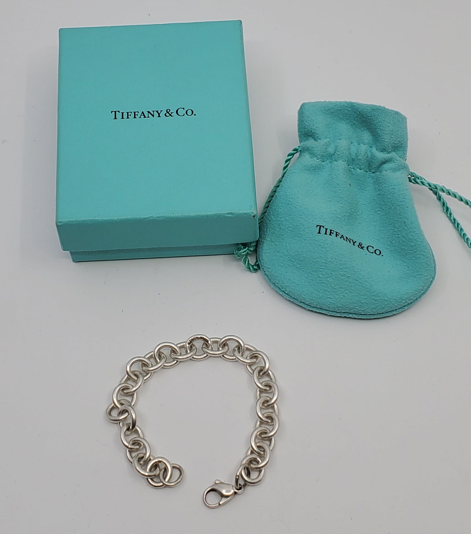 Tiffany & Co Sterling Silver Bracelet with Box: Sterling Silver Bracelet, marked on the middle T&CO Ag 925, with it's original Pouch and Box7 1/4" x 3/8"Weight: 26,9 g