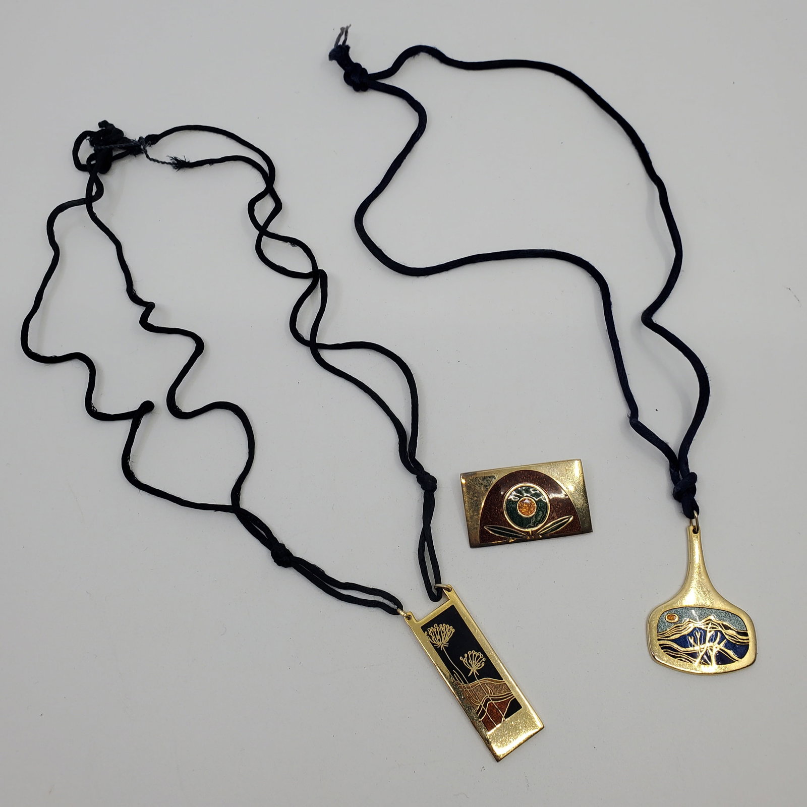 De Passille-Sylvestre, Lot of 3 Jewelry: Including 2 Necklace and one brooch, all gold tone with Enamel and all Marked Rectangular Pendant : 2" x 3/4"Drop Shaped Pendant : 1 3/4" x 1 1/4"Brooch : 1 1/2" x 1"