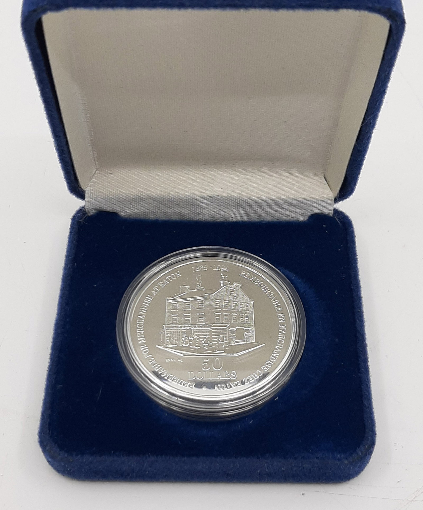 CANADA Timothy Eaton Co. $50 Fine Silver Trade Coin 1994: 31.63 grams of .9999 fine silver. Commemorating 125 years of the Eaton's department store chain. Was valid for $50 in merchandise. Proof condition, encapsulated and boxed.
