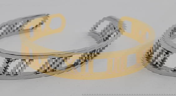 TIFFANY & Co. 18K Yellow Gold Open Atlas Roman Numeral Cuff Bracelet: 26.22 grams. Jeweller's evaluation (in French) included.