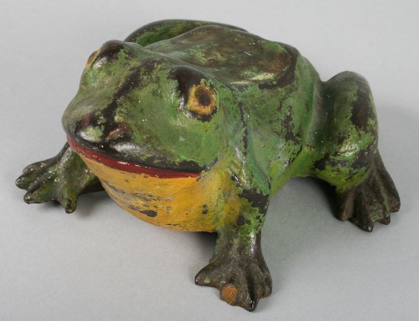 Cast Iron Frog Doorstops and a Cricket Bootjack: American School, 20th Century, Three Vintage Cast Iron Frog Doorstops and a Cast Iron Cricket Bootjack (four objects), approximately 3 inches tall (each frog); 11-1/2 inches (cricket length). Provenan