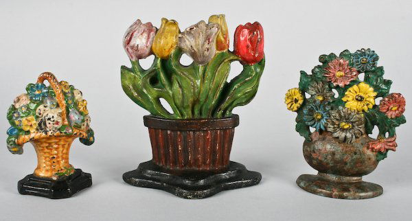 Three Vintage Cast Iron Flower Basket Doorstops: American School, 20th Century, Three Vintage Cast Iron Flower Basket Doorstops including a Pennsylvania German Folk-Art Basket of Tulips, circa 1870, ranging in size from 5-3/4 to 8-1/4 inches (height