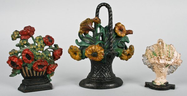 Three Vintage Cast Iron Flower Basket Doorstops: American School, 20th Century, Three Vintage Cast Iron Flower Basket Doorstops, ranging in size from 5-3/4 to 9-3/4 inches (height). Provenance: The Betty Gordon Estate.