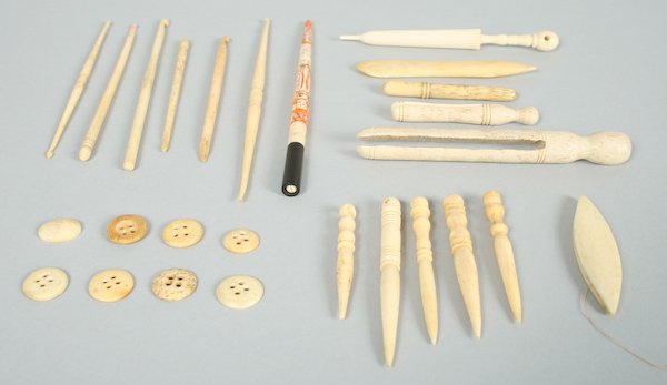 Collection of Finely Carved Inuit Ivory and Bone o: Collection of Finely Carved Inuit Ivory and Bone Fish, Bodkins, Crochet Hooks, Needle Cases, Clothes Pins, Thread Winders, Buttons, a Brass Fish, a Celluloid Brooch, a Miniature Scrimshaw Cabochon and