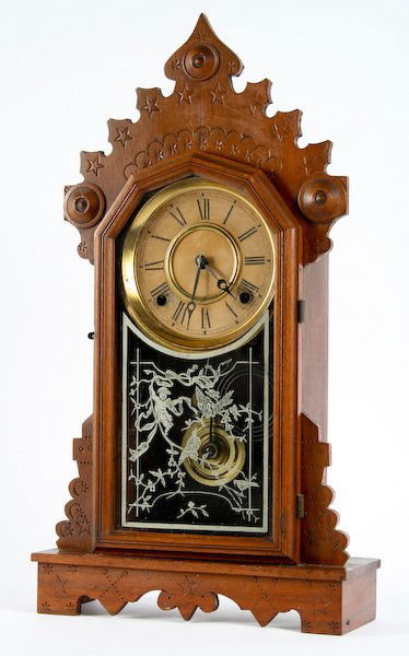 Mantle Clock and Cuckoo Clock: The E. Ingraham & Co., Carved and Stamped Walnut Gingerbread Mantle Clock with Stenciled Door, Original Winding Key and Pendulum, stamped within "Manufactured by / The E. Ingraham & Co. / Bristol, Con