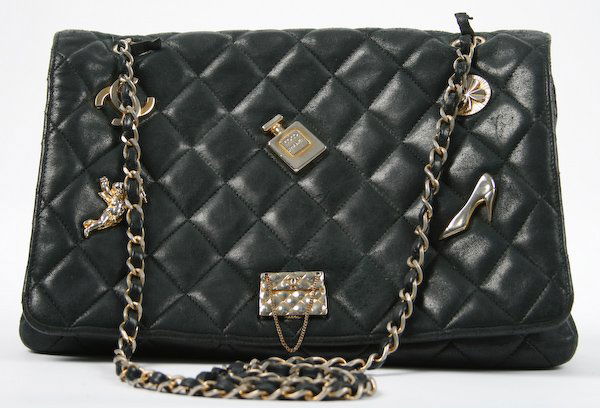 Chanel Quilted Black Leather Envelope Bag: Chanel Quilted Black Leather Envelope Bag, gold ornament and hardware, red leather interior, original storage bag and box, 7-1/2 x 11 x 3 inches. Provenance: The Betty Gordon Estate.