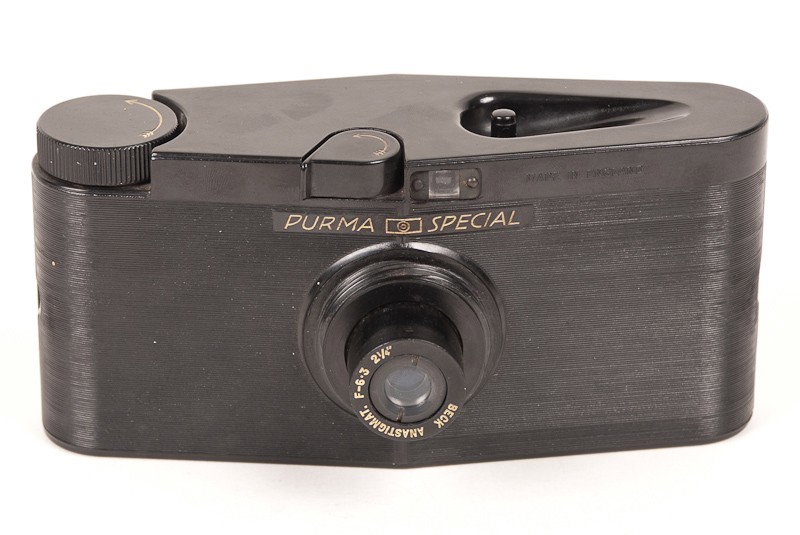 Purma Special Roll Film Camera: Purma Special Roll Film Camera with Beck Anastigmat Lens. Including a Box of (6) Lens Accessories. Manufactured by Purma Cameras Ltd. in London, England circa 1937. Provenance: The Kaprelian Camera Co