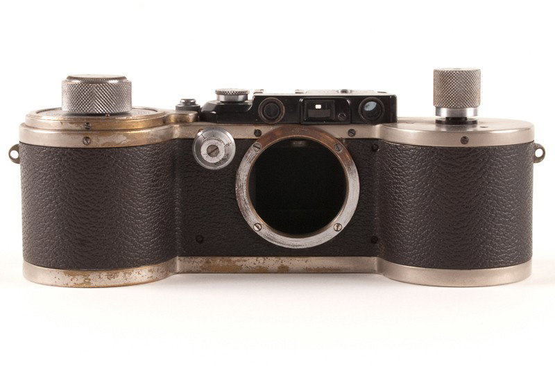 Leica 250 Reporter Body: Leica 250 Reporter Body (Serial No. 135648). An Early Model FF converted to GG in Nickel Finish with a top speed on 1/1000 sec. Manufactured by Ernst Leitz in Wetzlar, Germany circa 1934. Includes a R