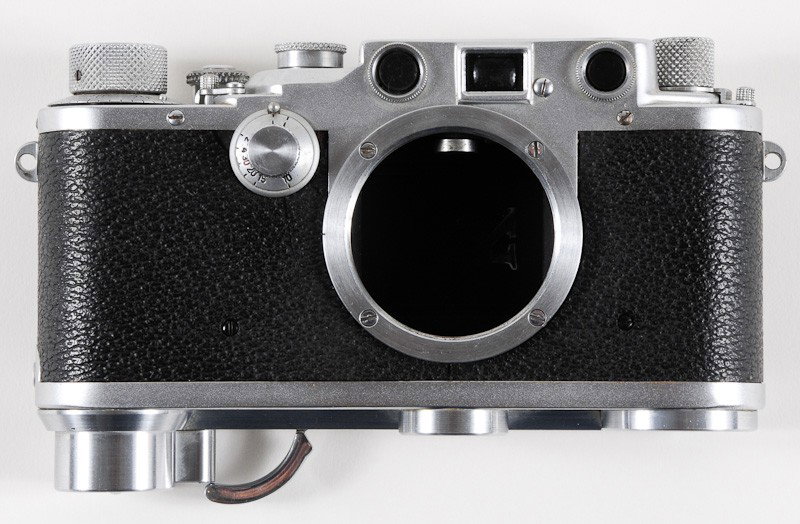 Leica IIIc Camera Body: Leica IIIc Camera Body (Serial No. 391122) with K Shutter and SCNOO Rapid Winder. Manufactured by Ernst Leitz in Wetzlar, Germany. Provenance: The Kaprelian Camera Collection, Philadelphia, PA.