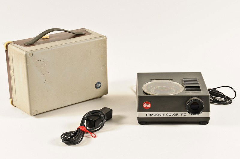 Group of 2 Leitz Slide Projectors: Group of 2 Leitz Slide Projectors including Model No. 315601 for 35mm Slides and Model Pradovit Color 110 for 110 Film Slides with Remote Advance Cord. Manufactured by Ernst Leitz in Wetzlar, Germany.