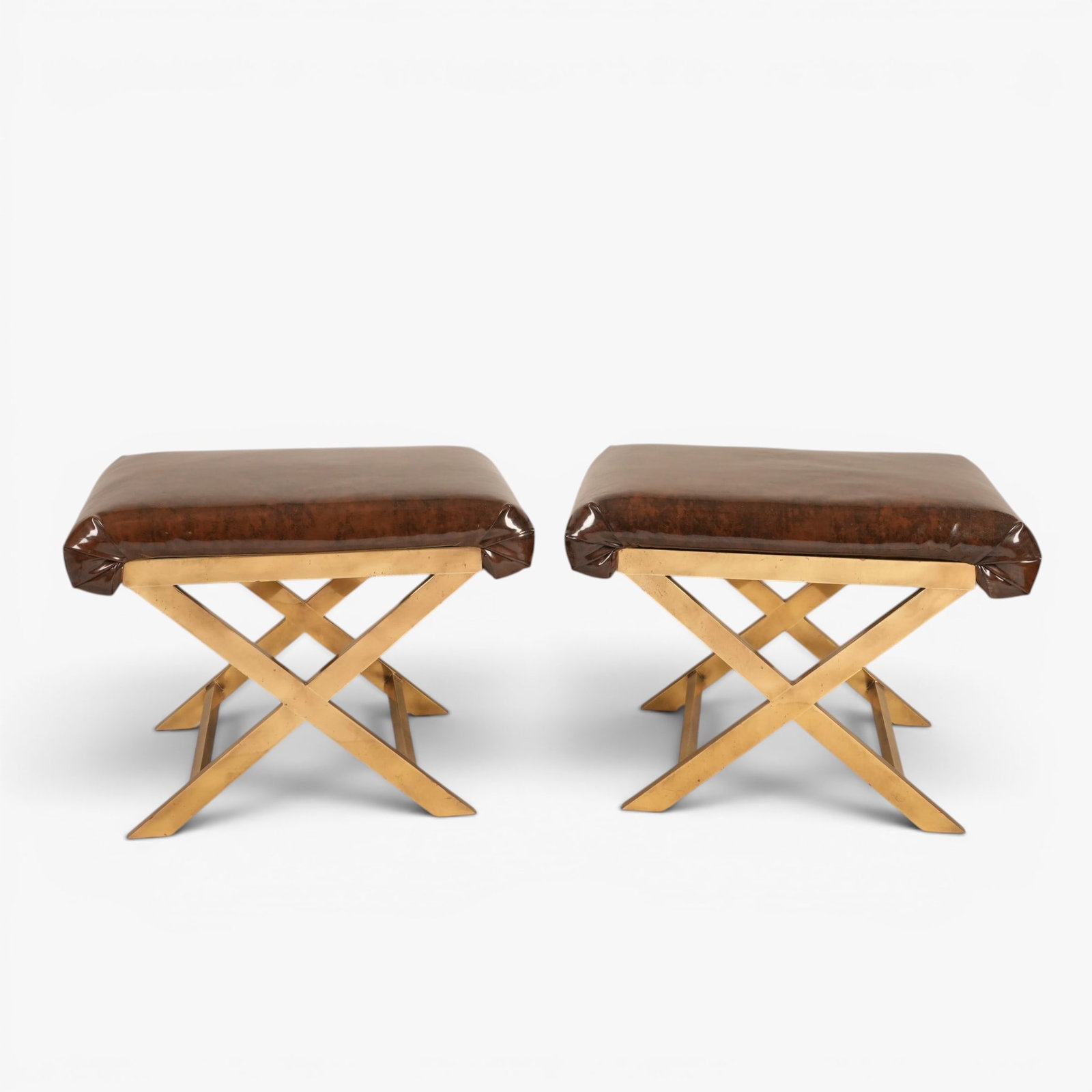 A Pair of Vintage Weiman-Warren Style Brass X-Base Ottomans, Italy, Circa 1970's: Brass bases with faux brown patent leather upholstered seats The collection of Frank and Irene Giuffrida, owners of the famous Hilltop Steakhouse, Saugus, MA