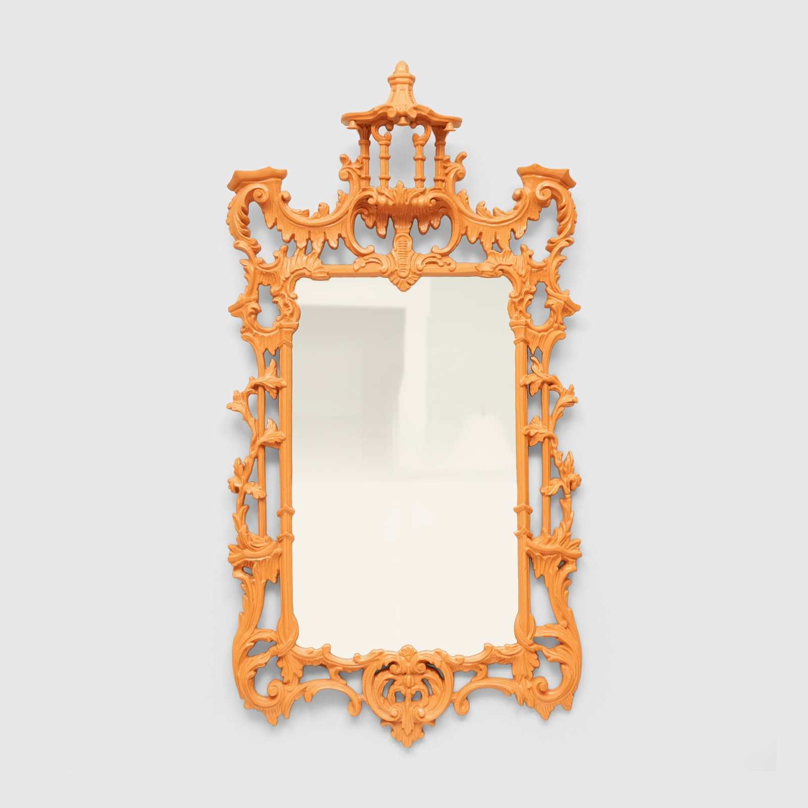 Chinese Chippendale style mirror: 20th century, the elaborately carved frame with a Chinese influenced pagoda at the center top supported by four columns, the roofline with three suspended bells, the sides intricately carved with entw