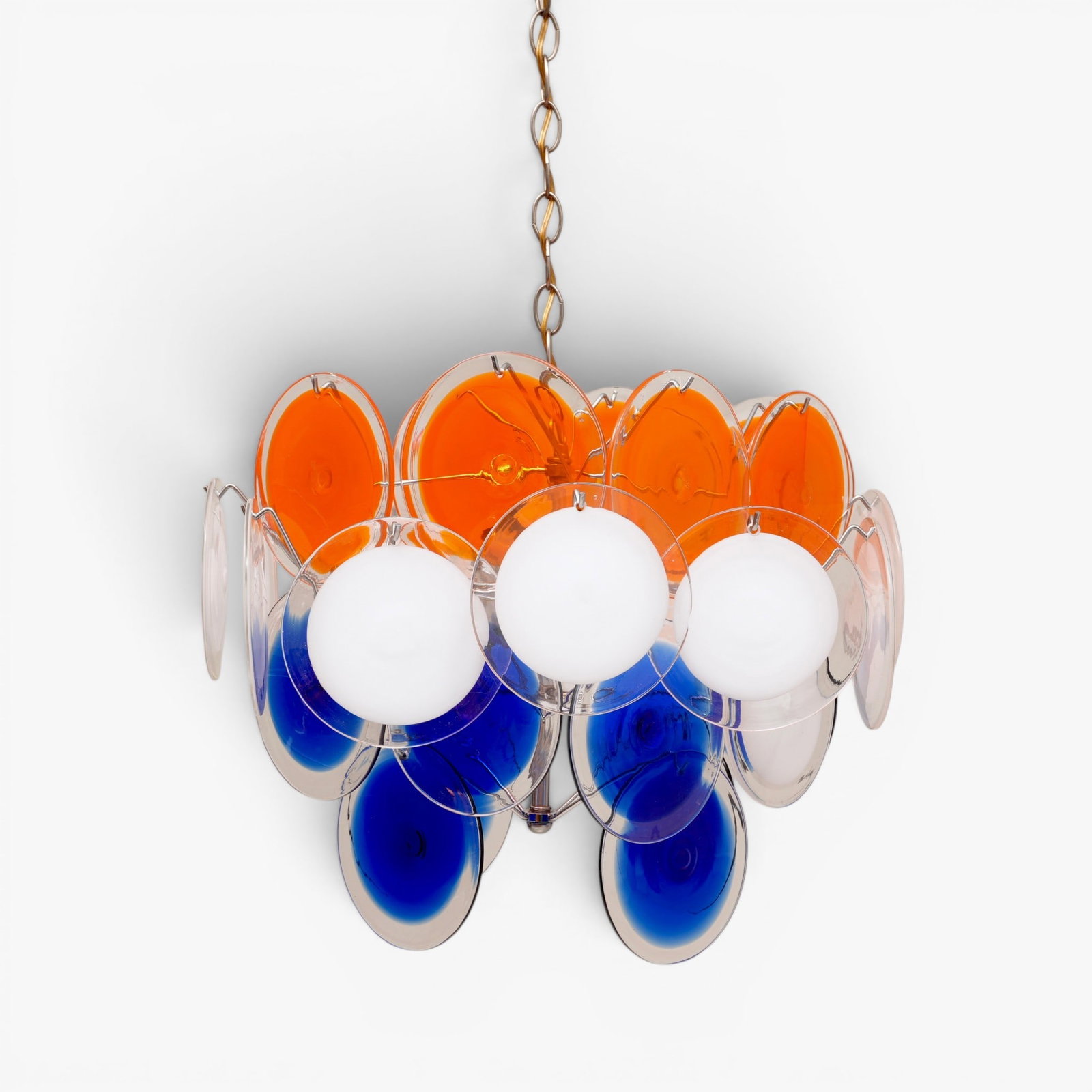 Italian Vistosi Murano Glass Disc Chandelier, circa 1970's: Mid 20th century, four tiered chrome frame with 8 bulb sockets, 10 blue, 9 orange, 10 white and clear glass discs - three discs marked with Made in Italy labels. 38" H including chain The collection o