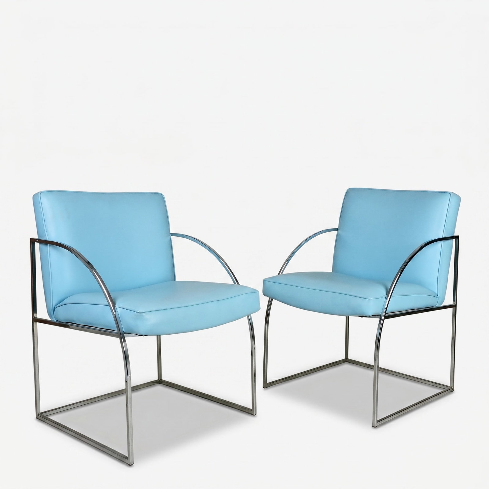 A Pair of Mid Century Chrome and Baby Blue Upholstered Chairs Attributed to Milo Baughman: Vintage modern chrome base frame with sloping armrest and baby blue vinyl upholstery The collection of Frank and Irene Giuffrida, owners of the famous Hilltop Steakhouse, Saugus, MA