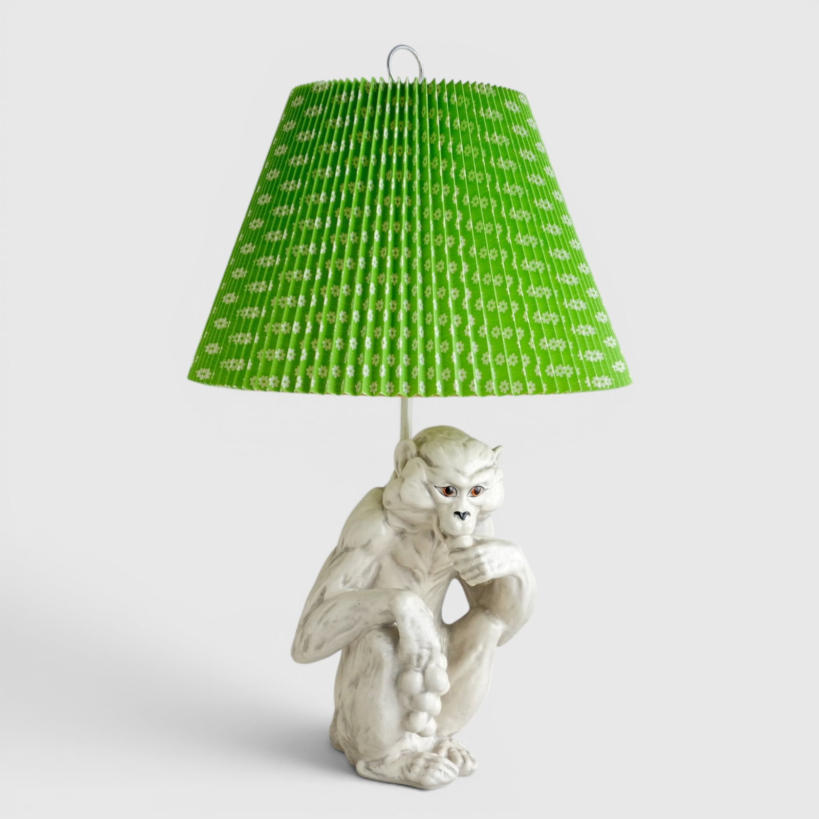 Hollywood Regency Italian Majolica Monkey Form Table Lamp with Green Shade, Italy, Circa 1960-70's: Hand painted, white glaze majolica, green pleated shade with white floral pattern, felt base not removed to look for Italy mark The collection of Frank and Irene Giuffrida, owners of the famous Hillto