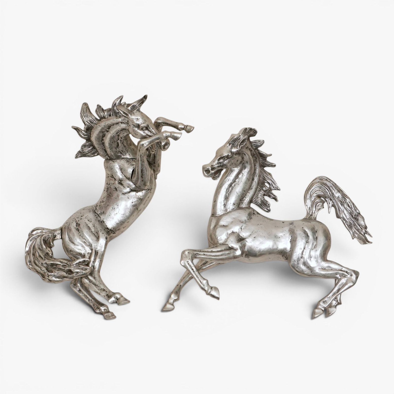 Vintage Metal Horse Form Wall Sculptures: Mid 20th century, two substantial silver tone cast metal horses in fighting pose, some parts cast separately The collection of Frank and Irene Giuffrida, owners of the famous Hilltop Steakhouse, Saugu