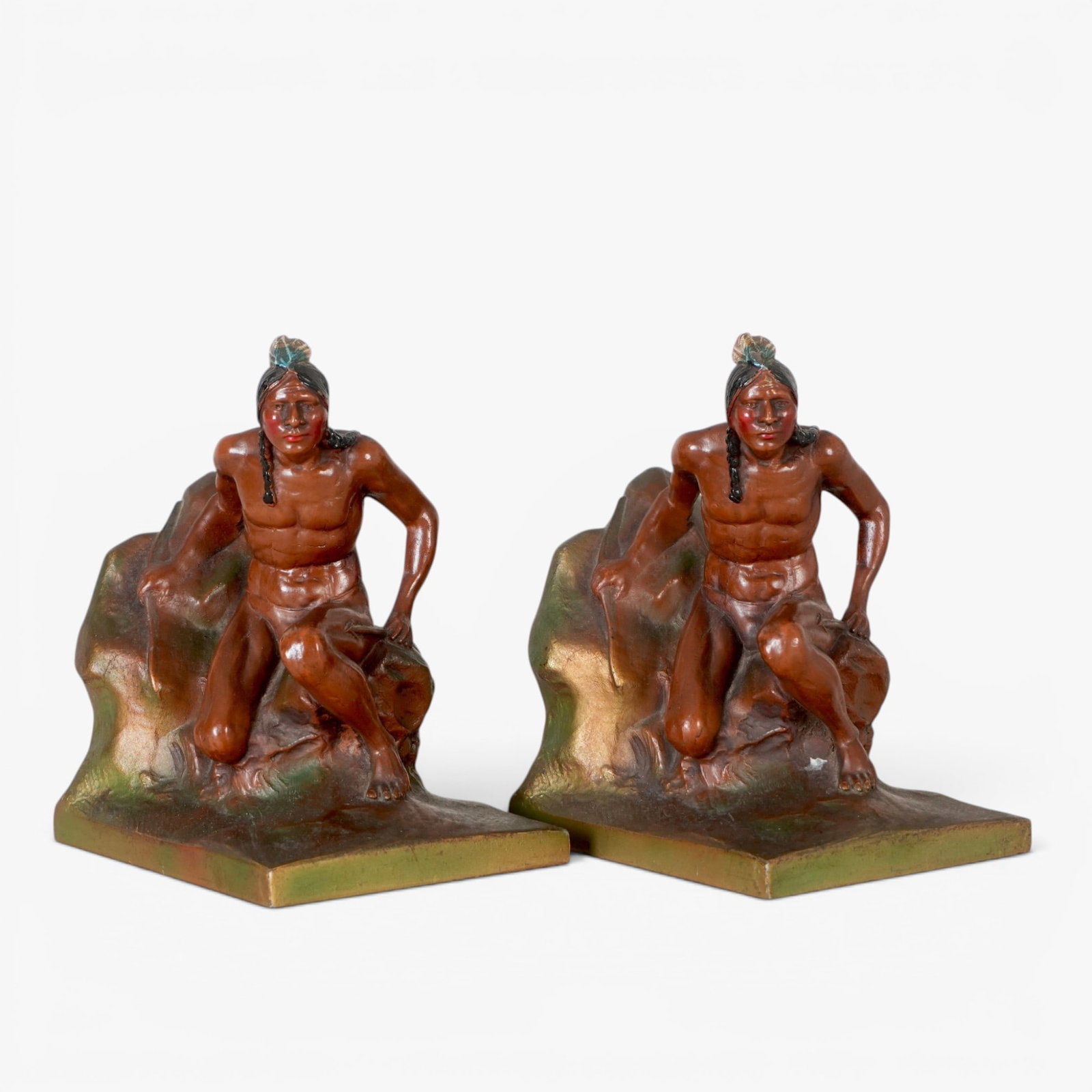 Vintage Cast Metal Native American Bookends: In a scouting pose, bronzed and enameled surface, makers mark of Kronheim & Oldenbush The collection of Frank and Irene Giuffrida, owners of the famous Hilltop Steakhouse, Saugus, MA