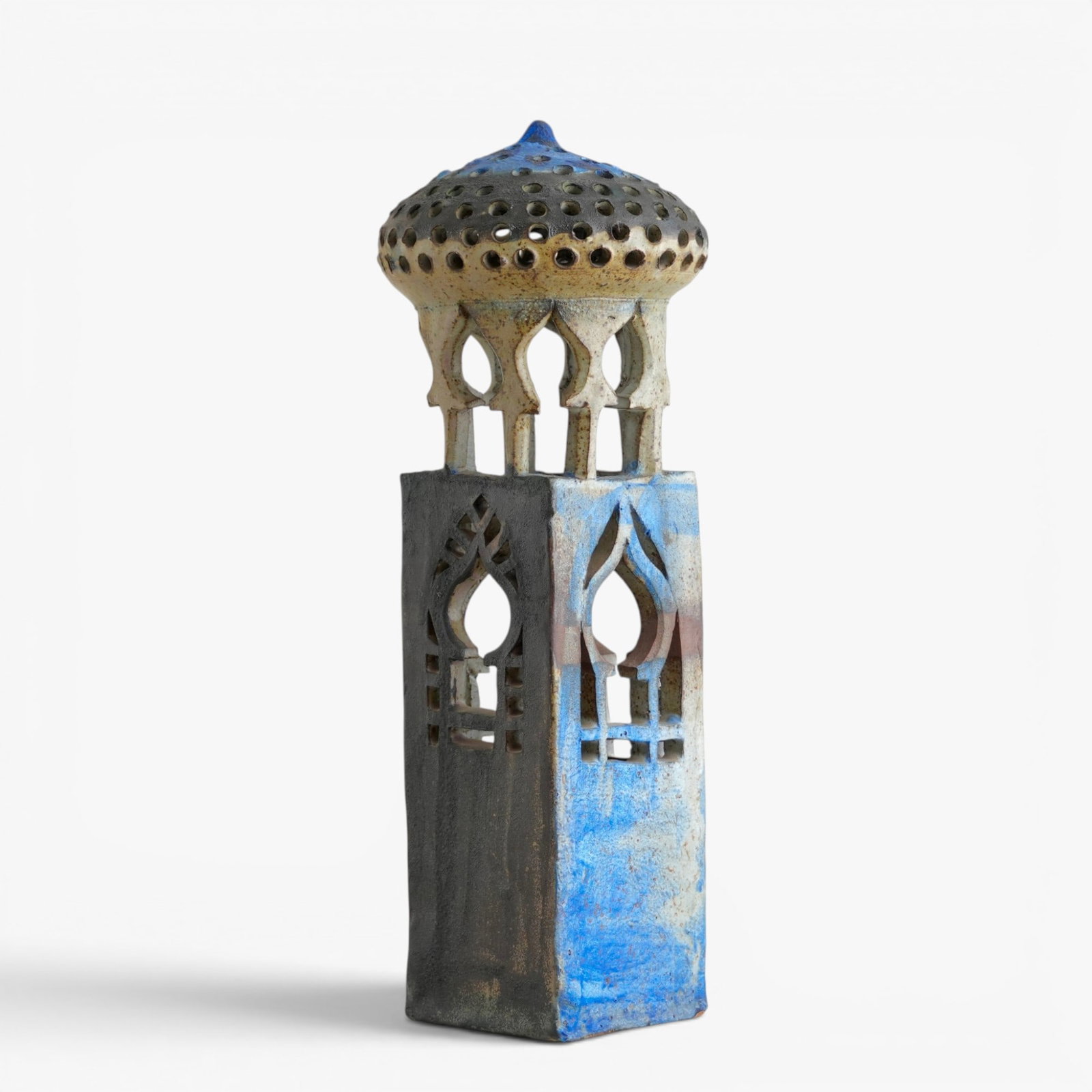 Modern Pottery "Mosque": The pierced dome shaped roof supported on six shaped posts set on a vertical, rectangular base, each side with openwork windows, glazed in blues and light gray The collection of Frank and Irene Giuffr