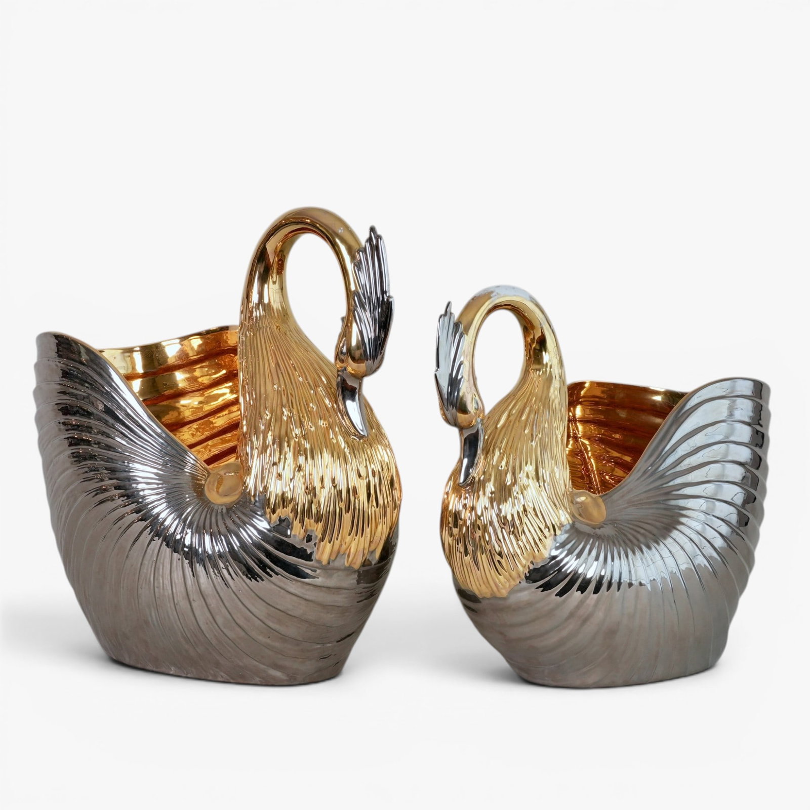 A Pair of Italian Gold Luster Porcelain Bisque Swans, Circa 1970's: The interior and exterior in brilliant gold luster, 'Italy' sticker on underside The collection of Frank and Irene Giuffrida, owners of the famous Hilltop Steakhouse, Saugus, MA