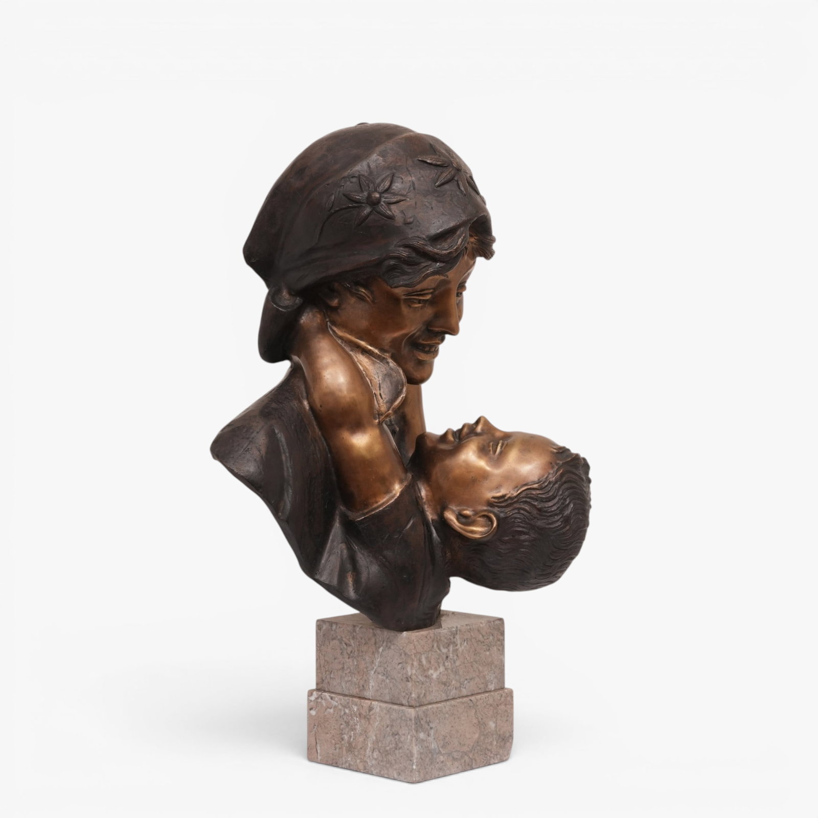 Italian Bronze Bust of a Female and Child: The mother looking down at the child in her arms, Signed A. Merente (Antonio Merente), mounted on a double stone base The collection of Frank and Irene Giuffrida, owners of the famous Hilltop